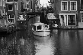 Boat cruising on canal (black and white)