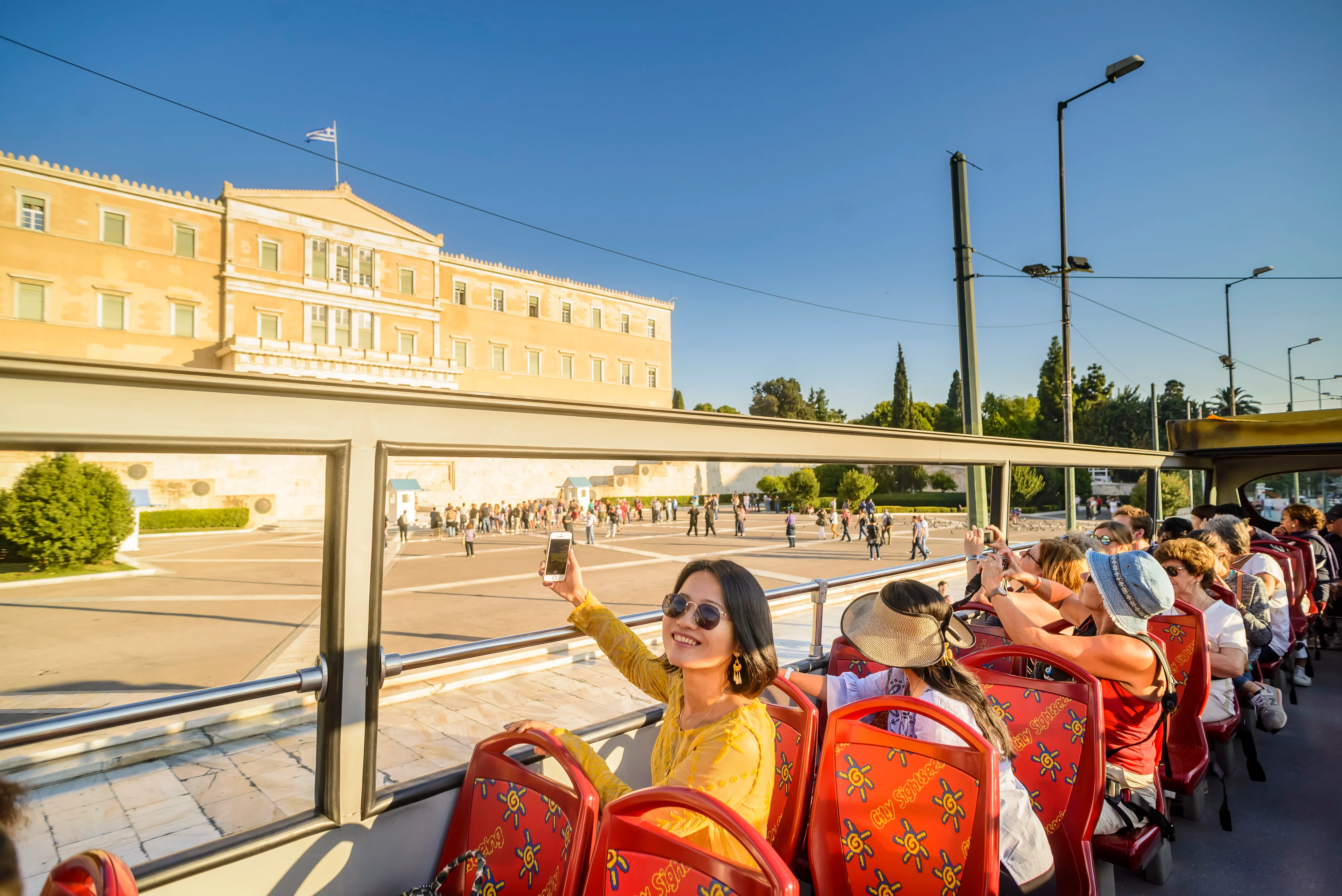 Tourists Enjoying the View from Open Top Bus