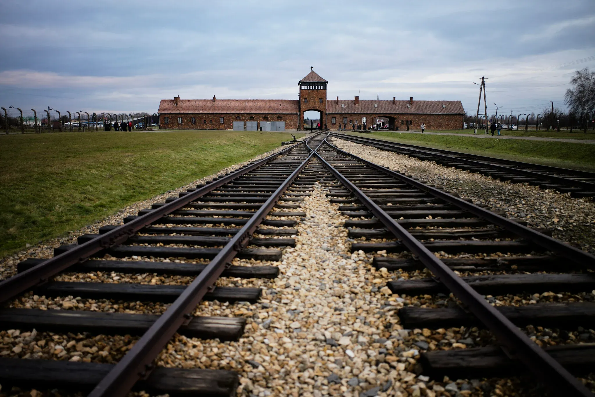 Birkenau entrance with rail tracks in spring