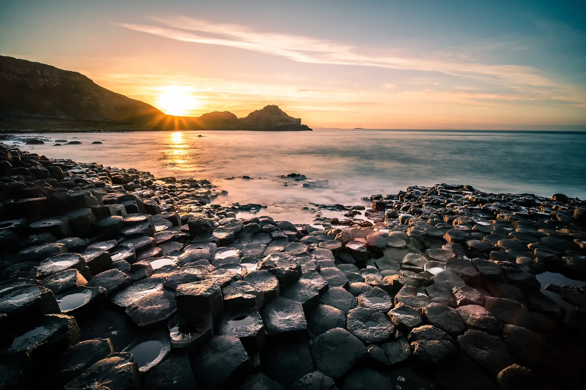 Sunrise over Giant's Causeway cliffs and sea