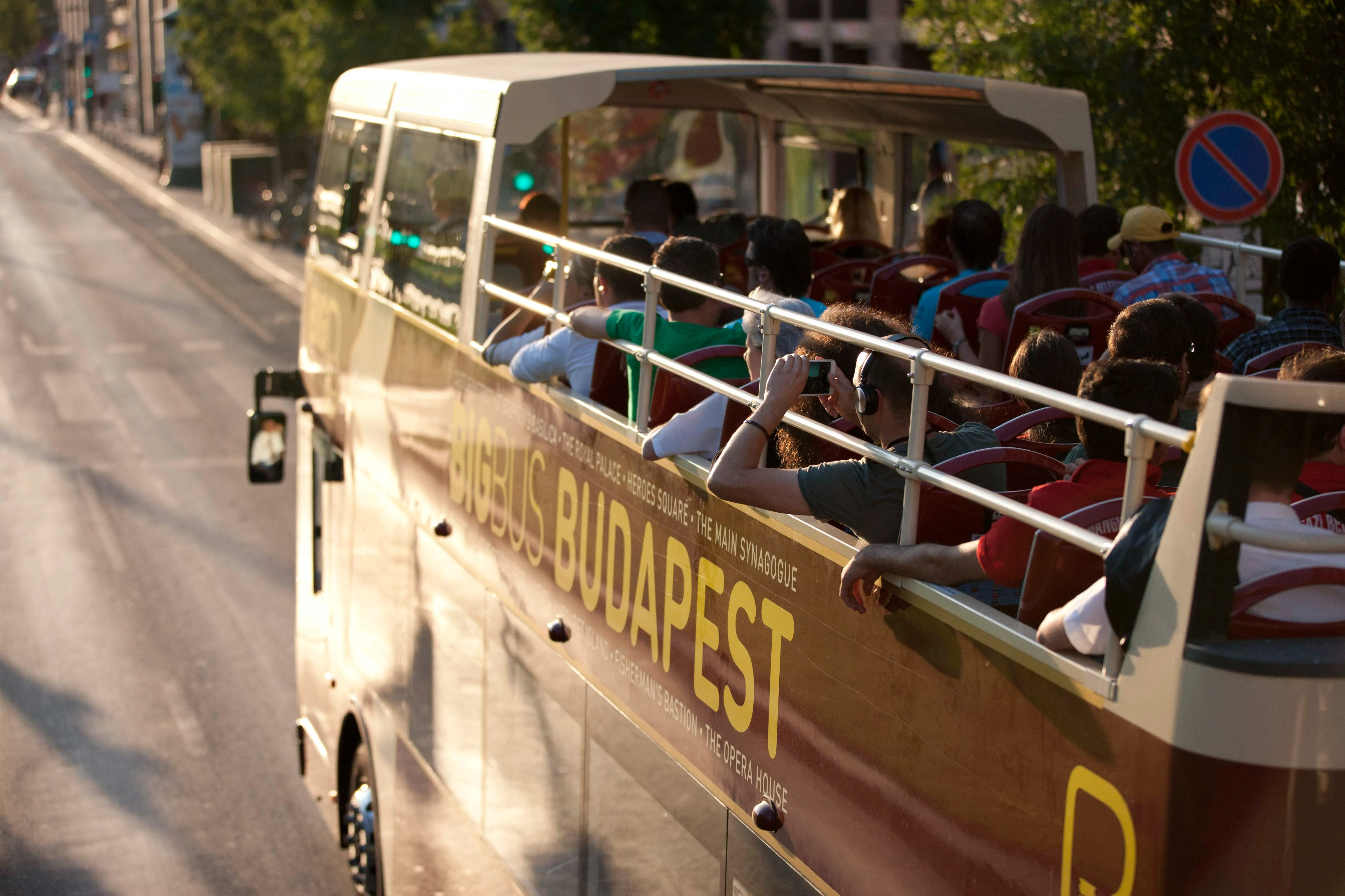 Tourists on open-top bus roof in Budapest