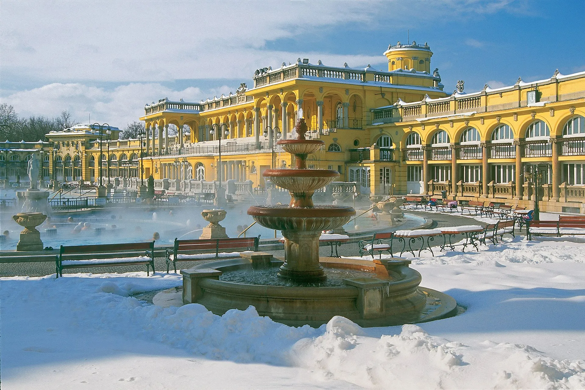 Snowy winter scene with steaming outdoor pools at Széchenyi Baths