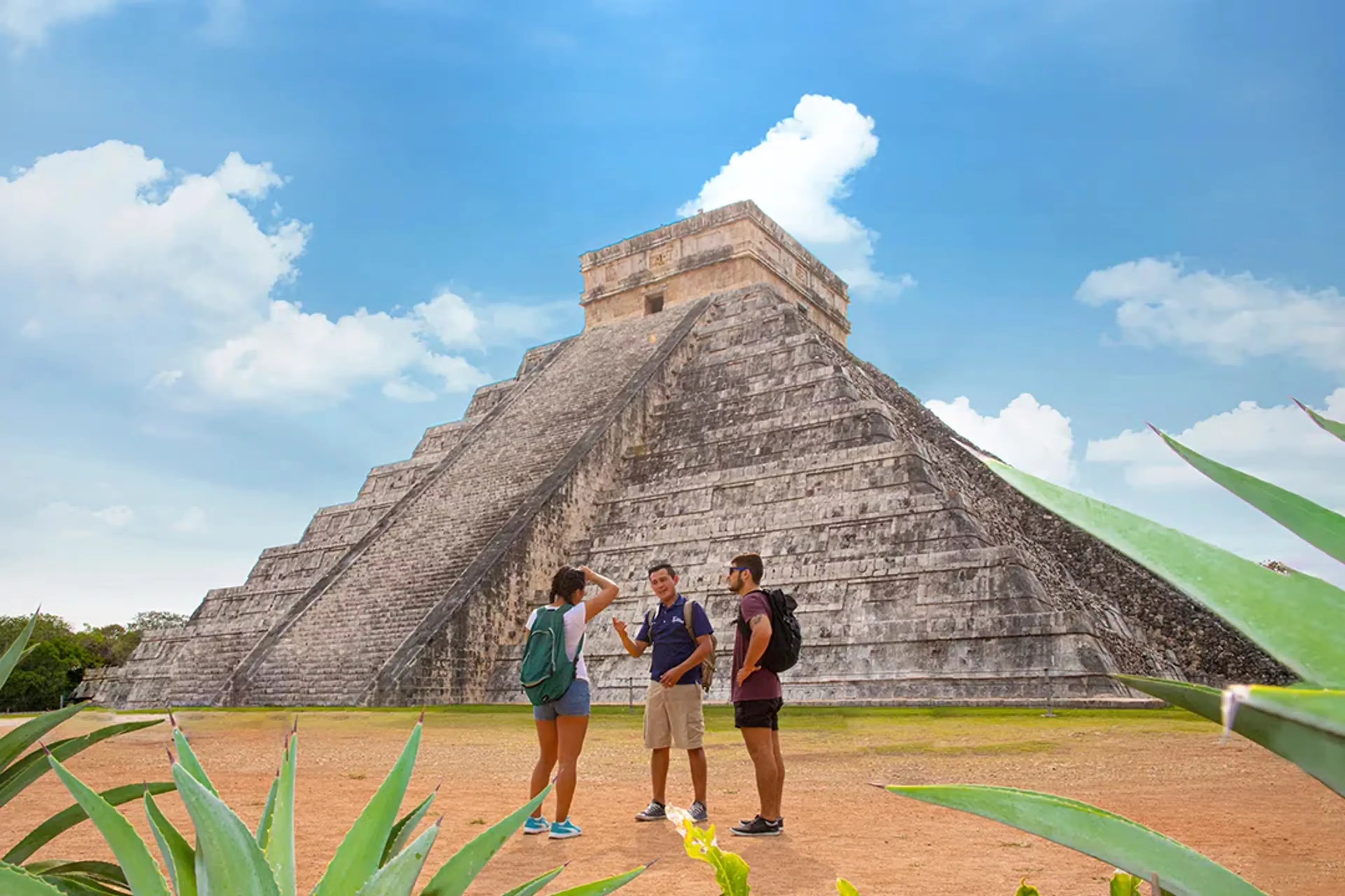 Visitors with a guide near Chichen Itza, representing tour and booking choices