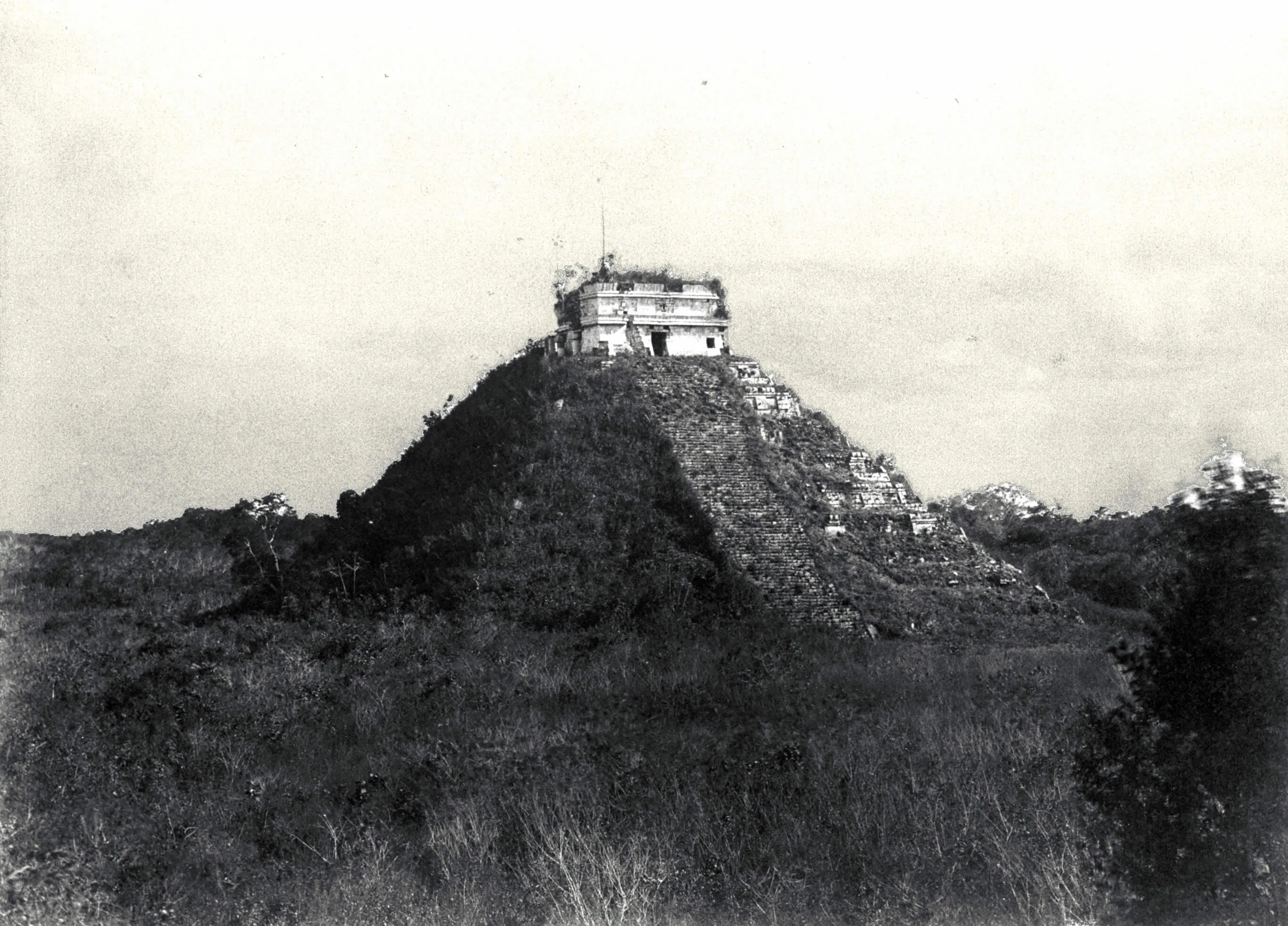 Historic depiction of Kukulcan Pyramid covered by vegetation