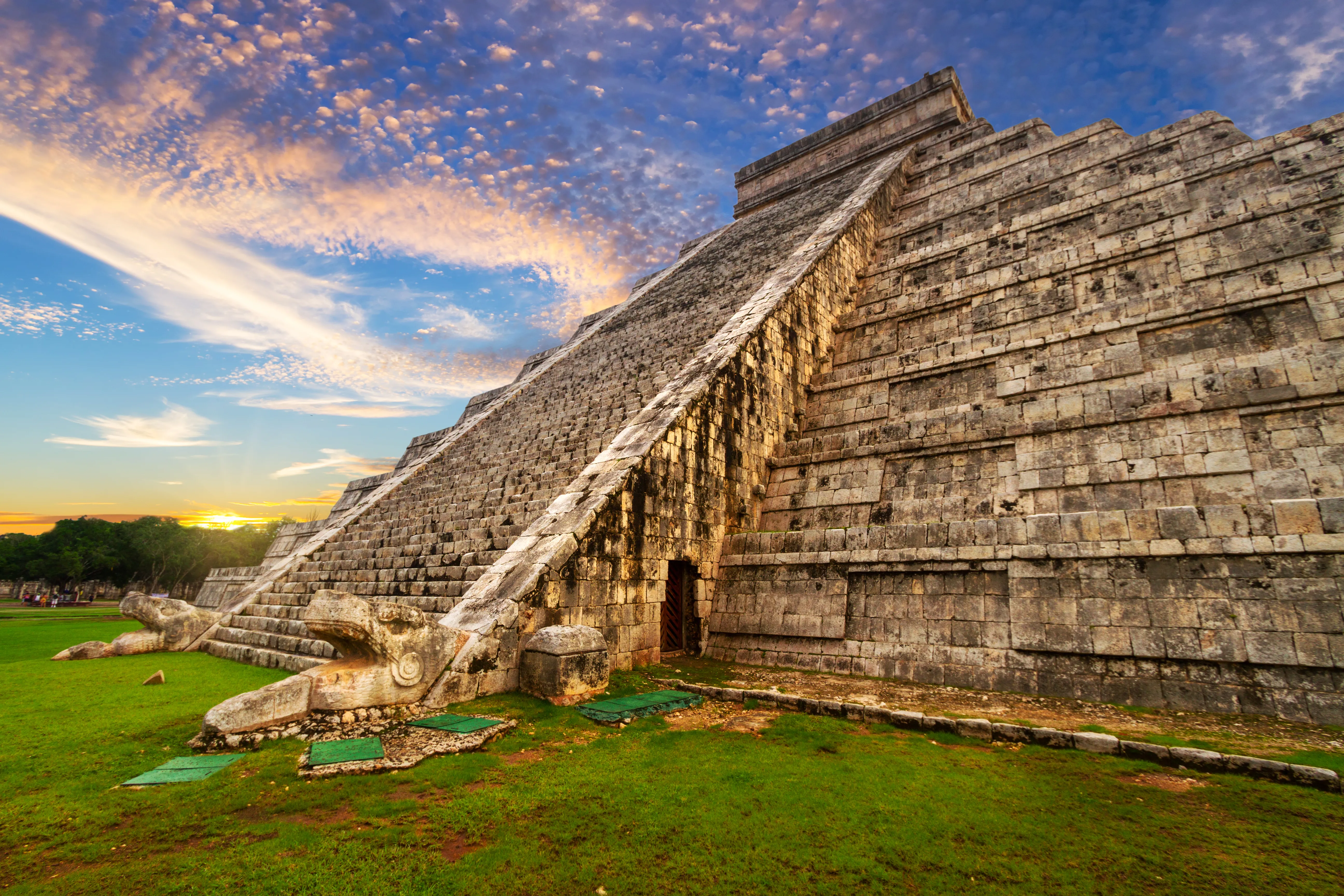 Stone statues and staircase base details at Chichen Itza
