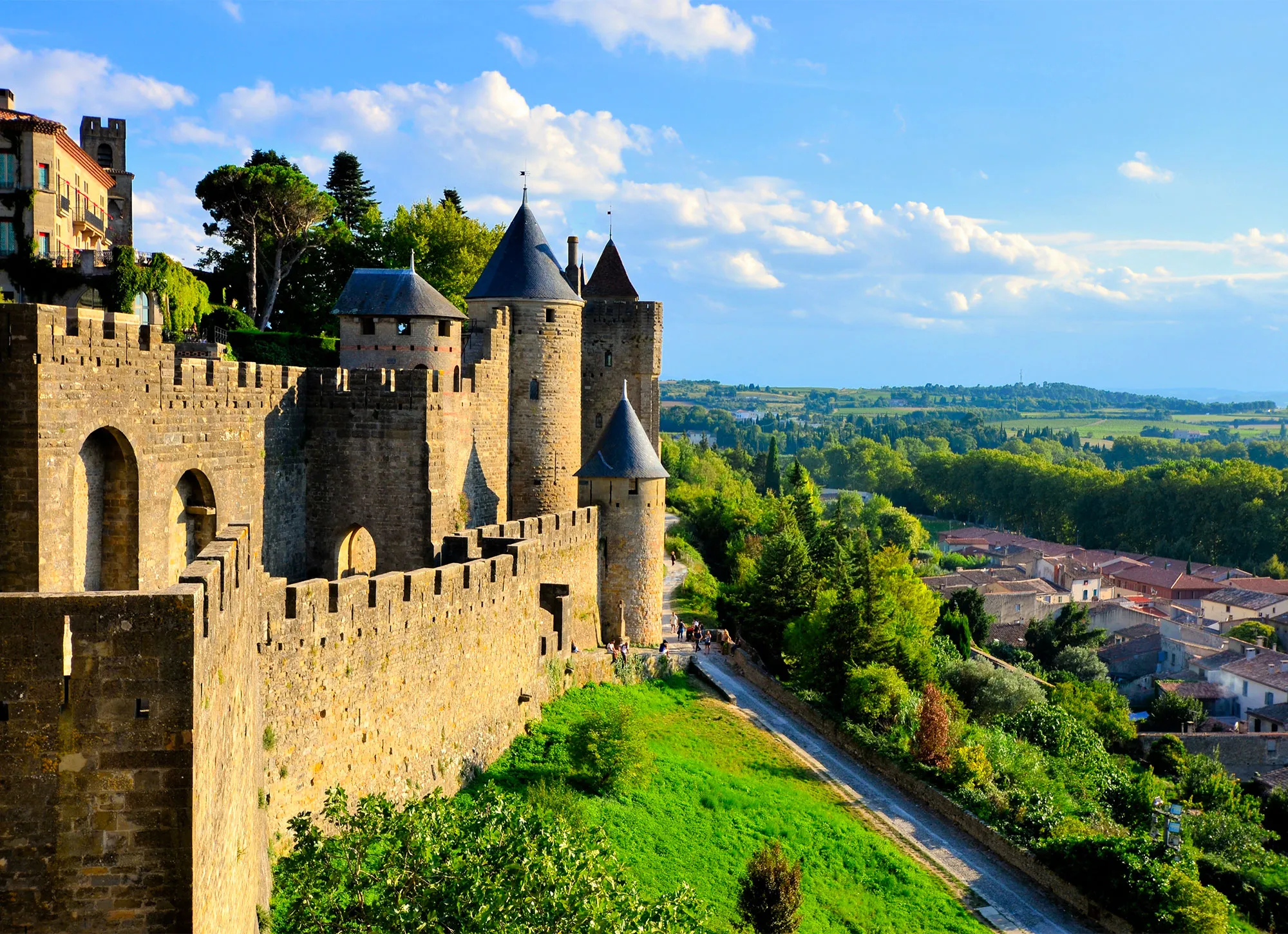 People walking along the grass outside the ramparts