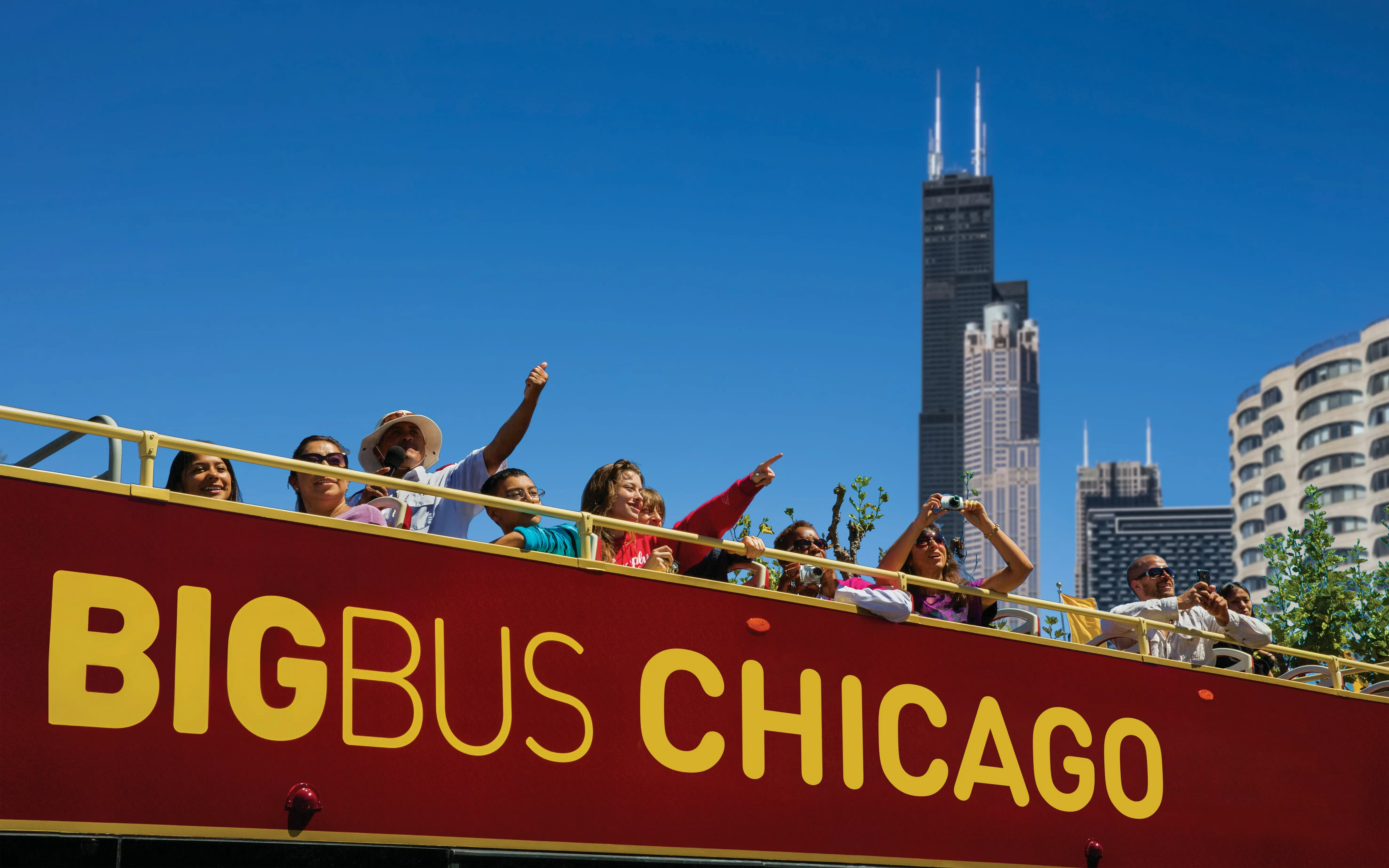 Happy tourists on top of a Chicago bus