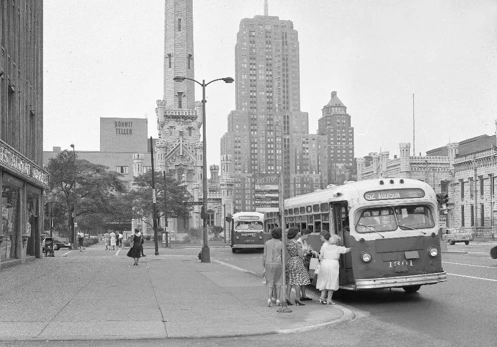 Passengers boarding a historic bus