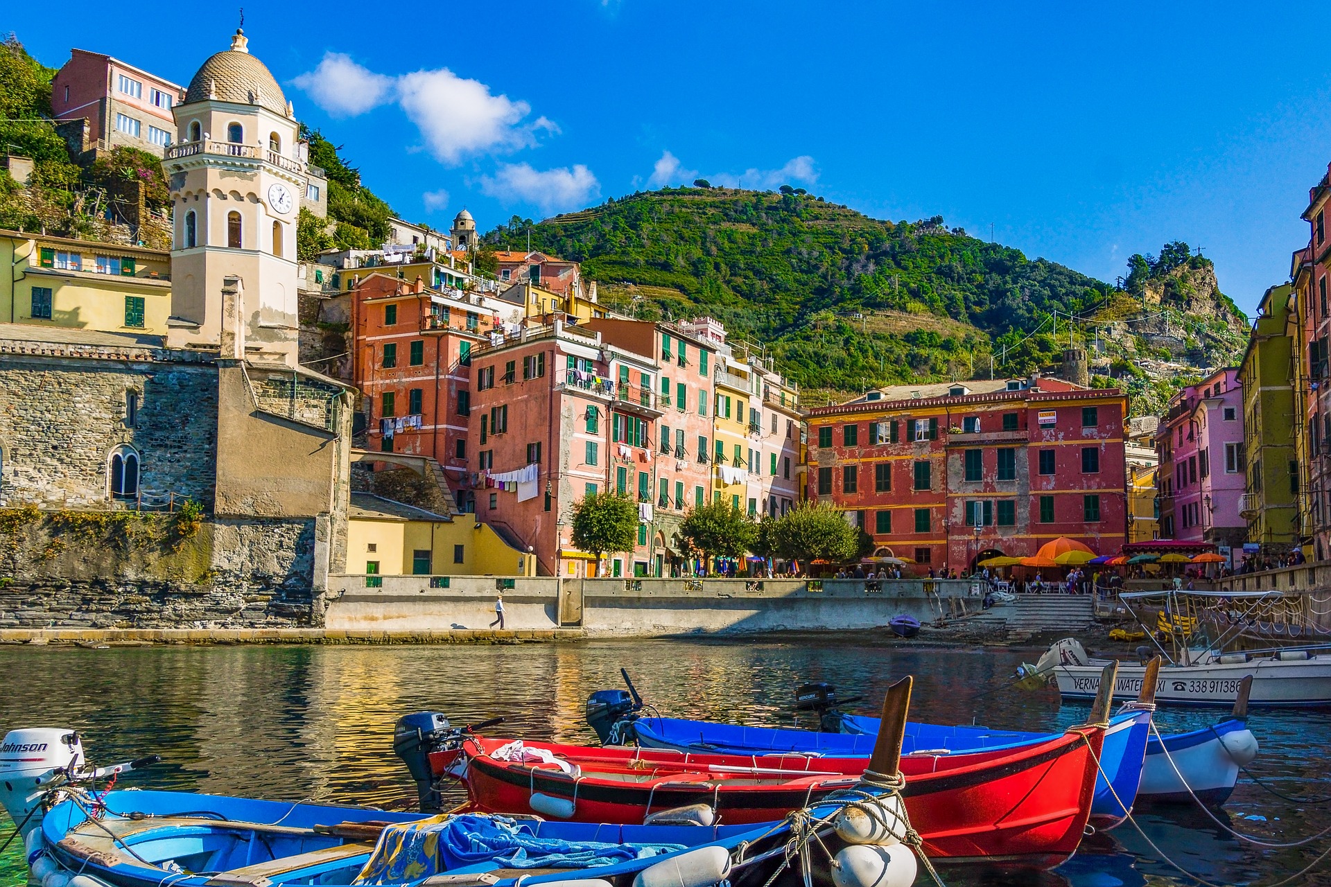 Colorful fishing boats tied closely together in Vernazza's natural harbor