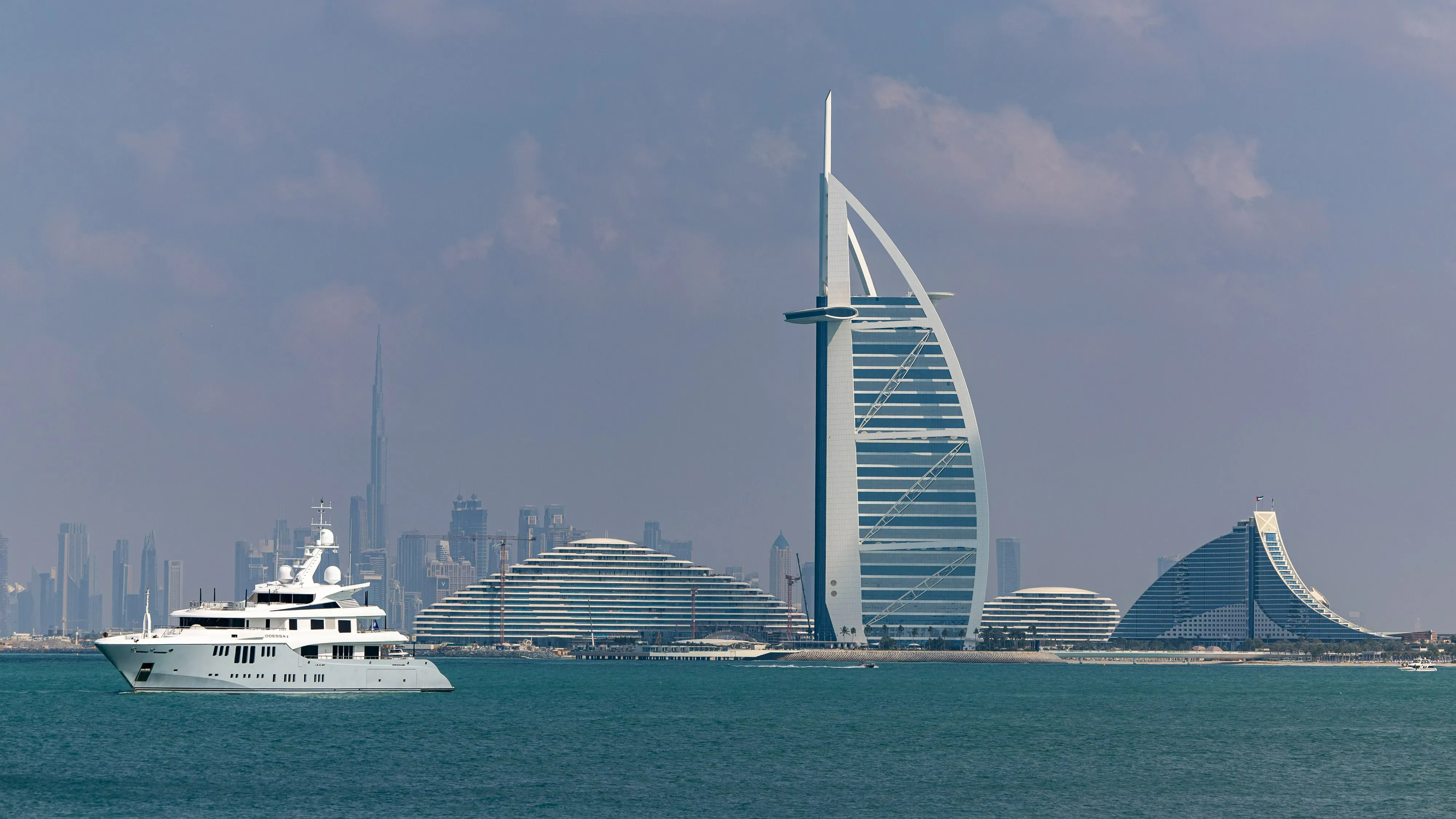 Daytime sea view of Burj Al Arab with megayacht