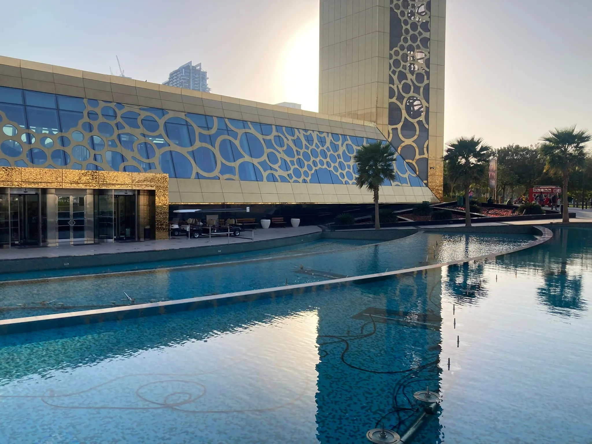 Families walking near the pools at the base of the Dubai Frame in Zabeel Park