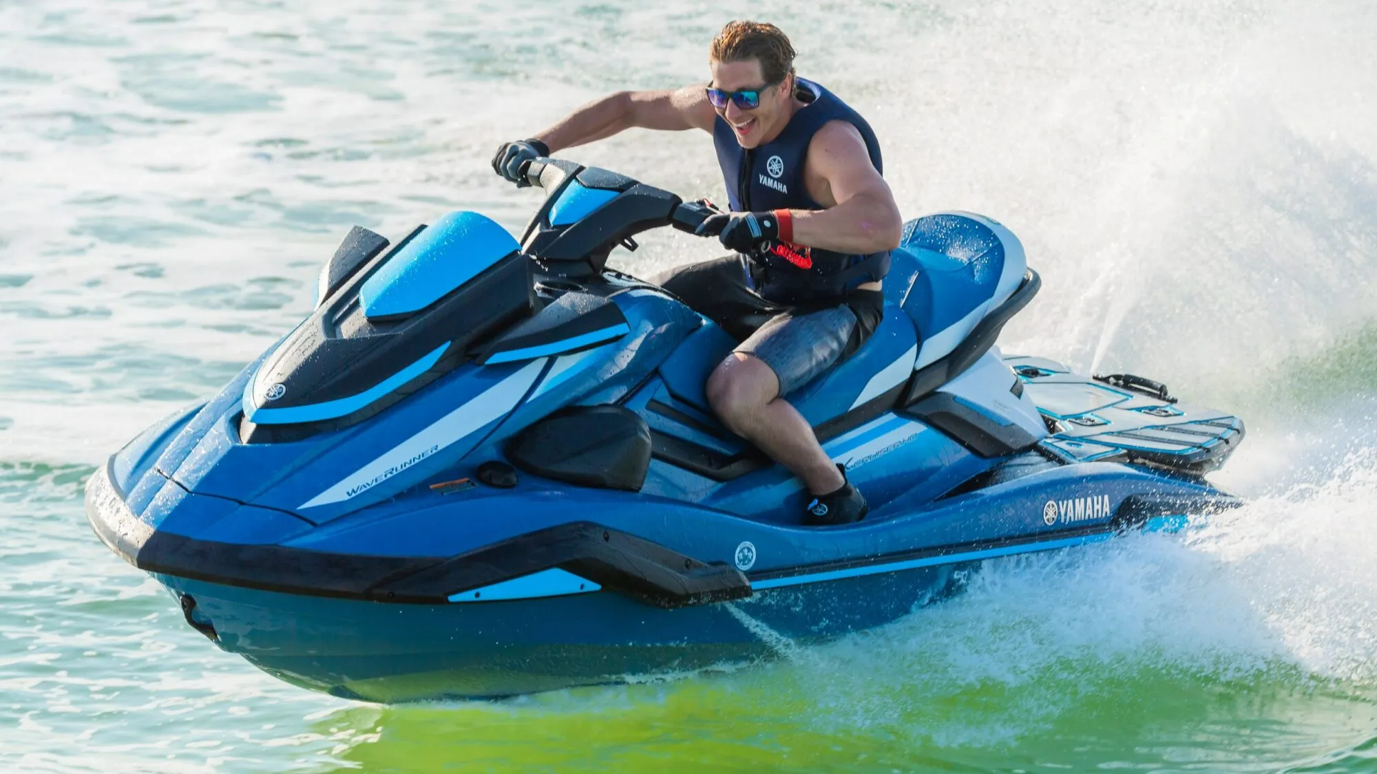 Happy man speeding on jet ski in Dubai