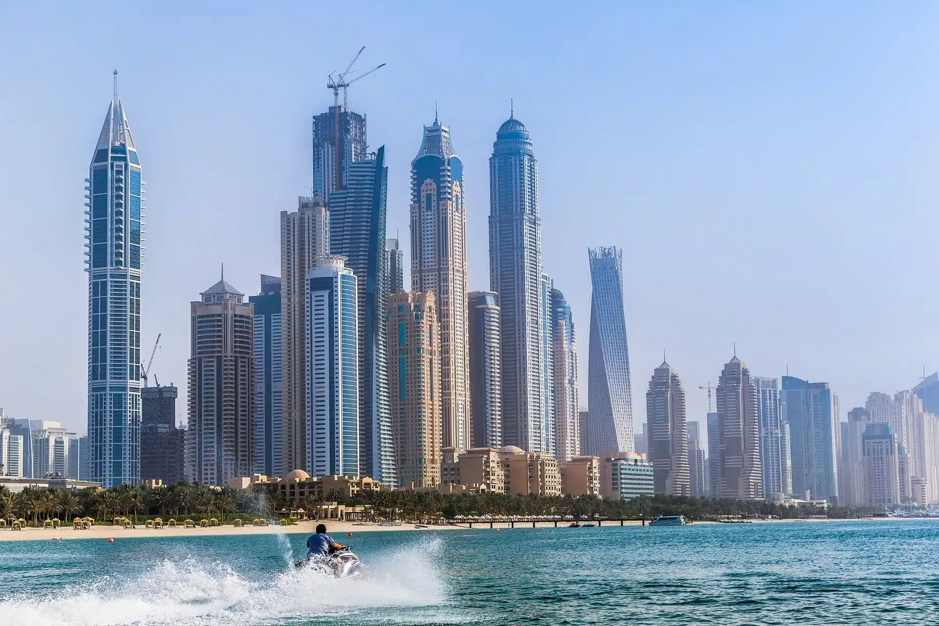 Solo rider speeding on a jet ski with Dubai skyscrapers in the background