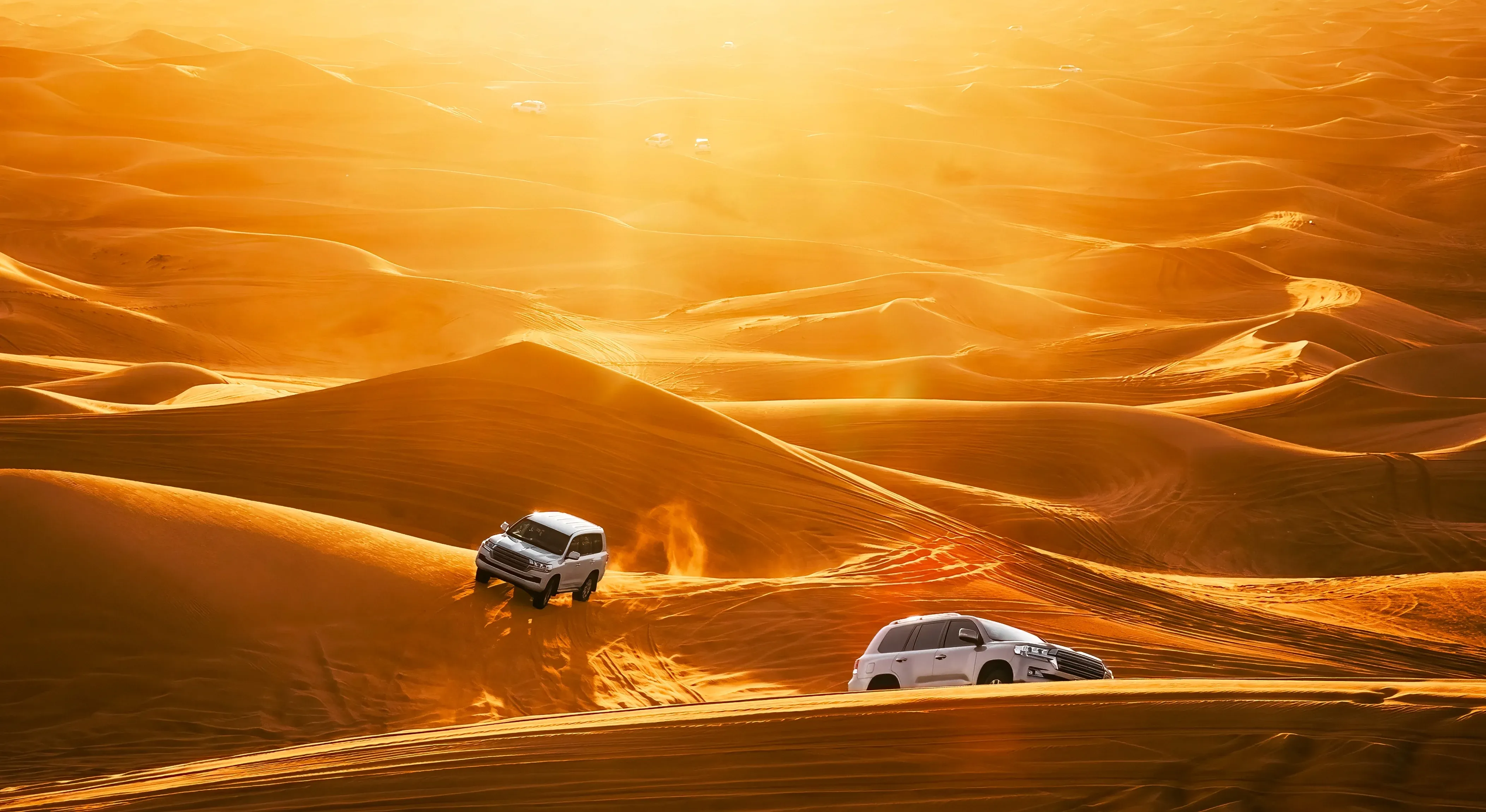 Off-road 4x4 vehicles lined up on the Dubai dunes