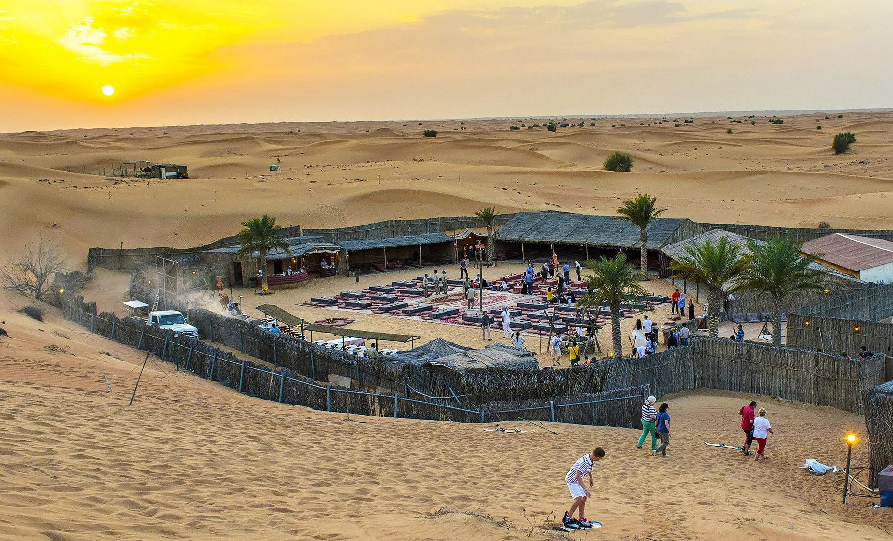 Premium-style desert camp seating with cushions and lanterns
