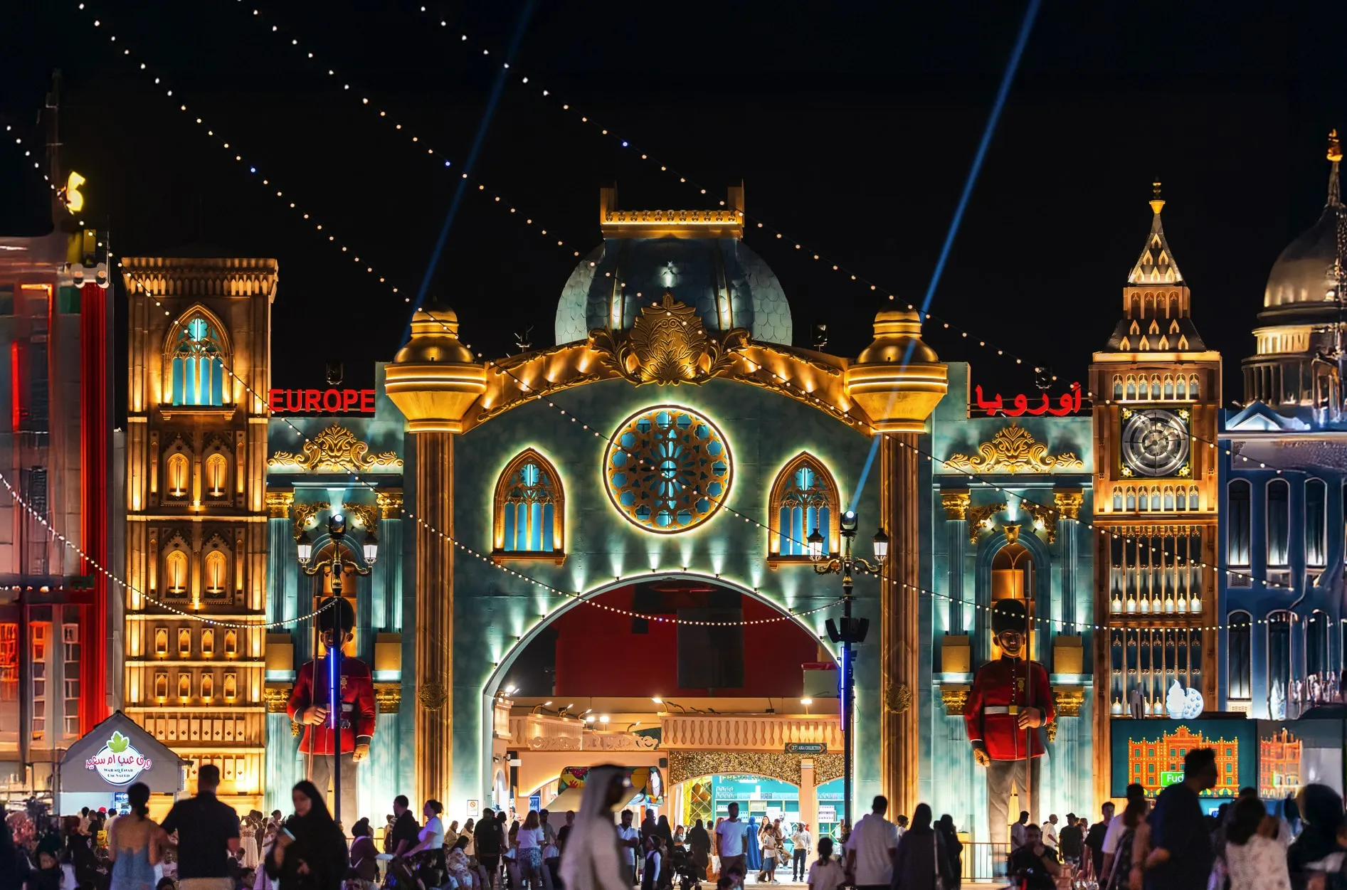 Row of ornate Global Village pavilions at dusk