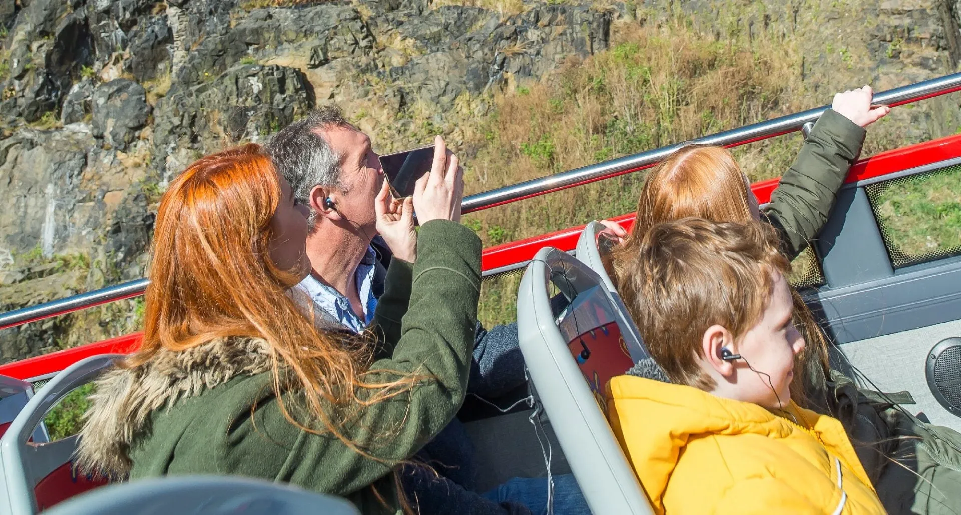 Tourists on bus roof looking at the castle