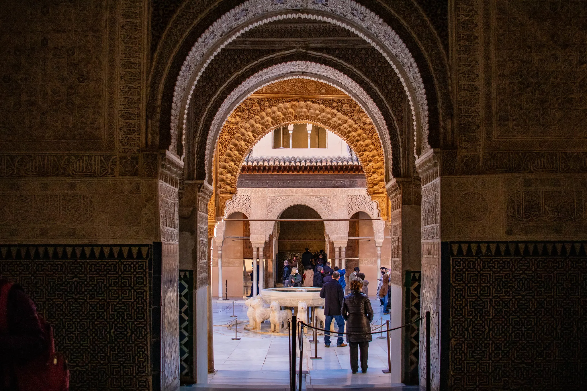 Visitors gathered in an Alhambra courtyard