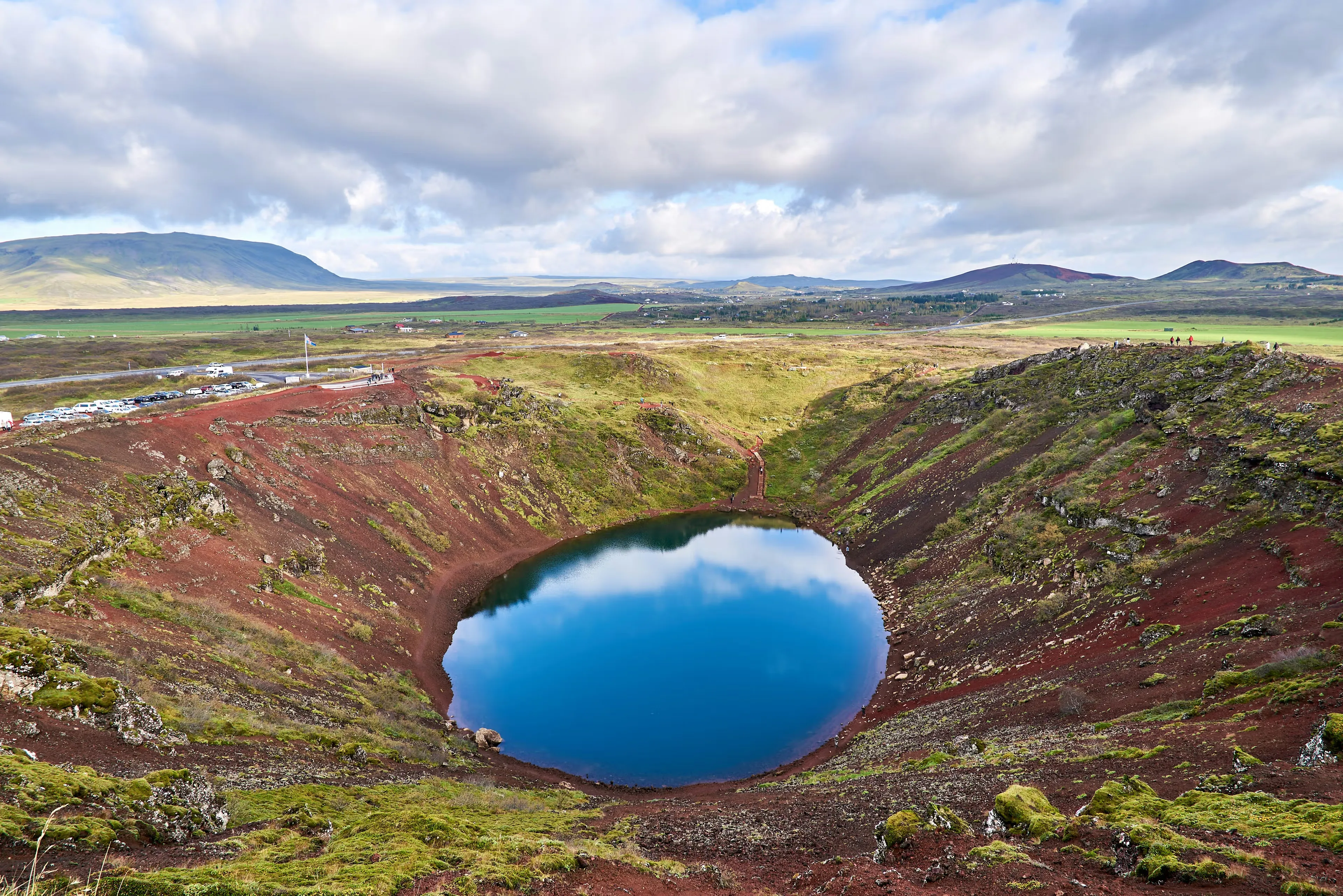 Kerið-style crater with blue lake and red-brown rim