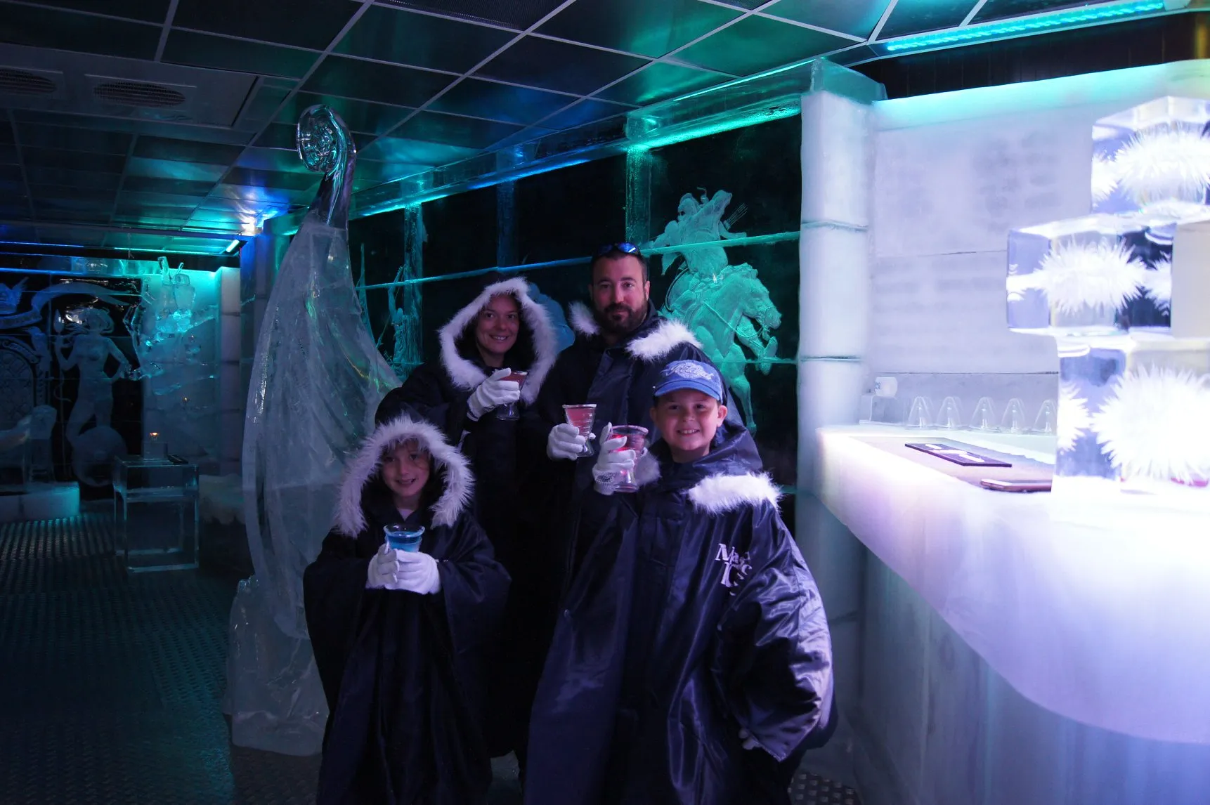 Family enjoying drinks inside the ice bar