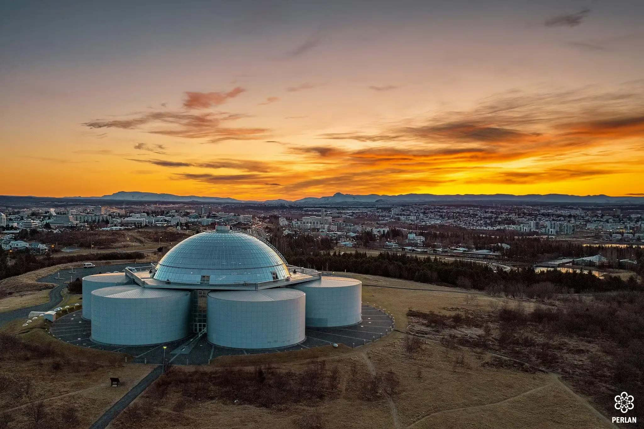 Perlan at sunset with glass dome and Reykjavík views