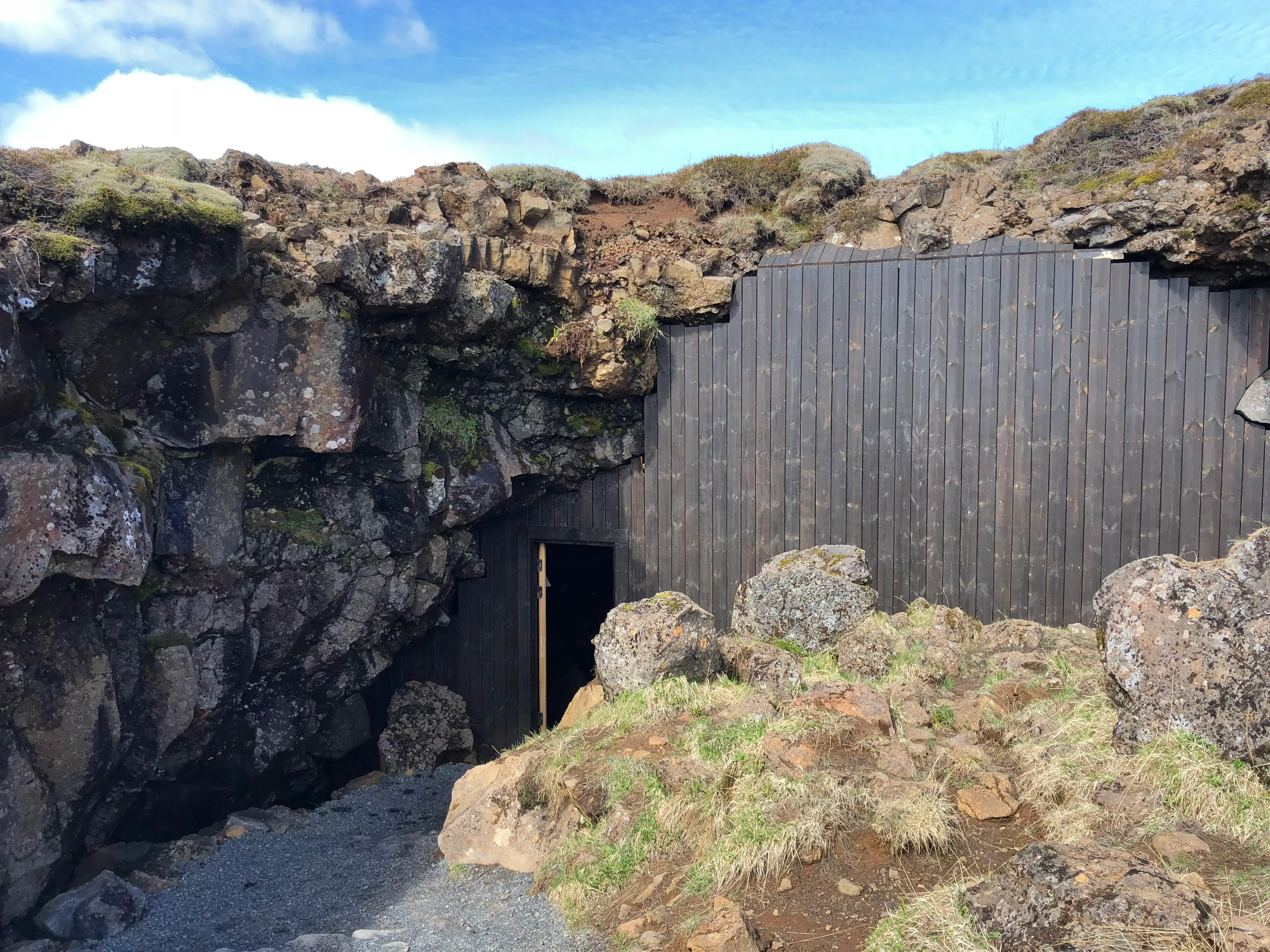 Lava Tunnel entrance with wooden walkway and snow-dusted lava