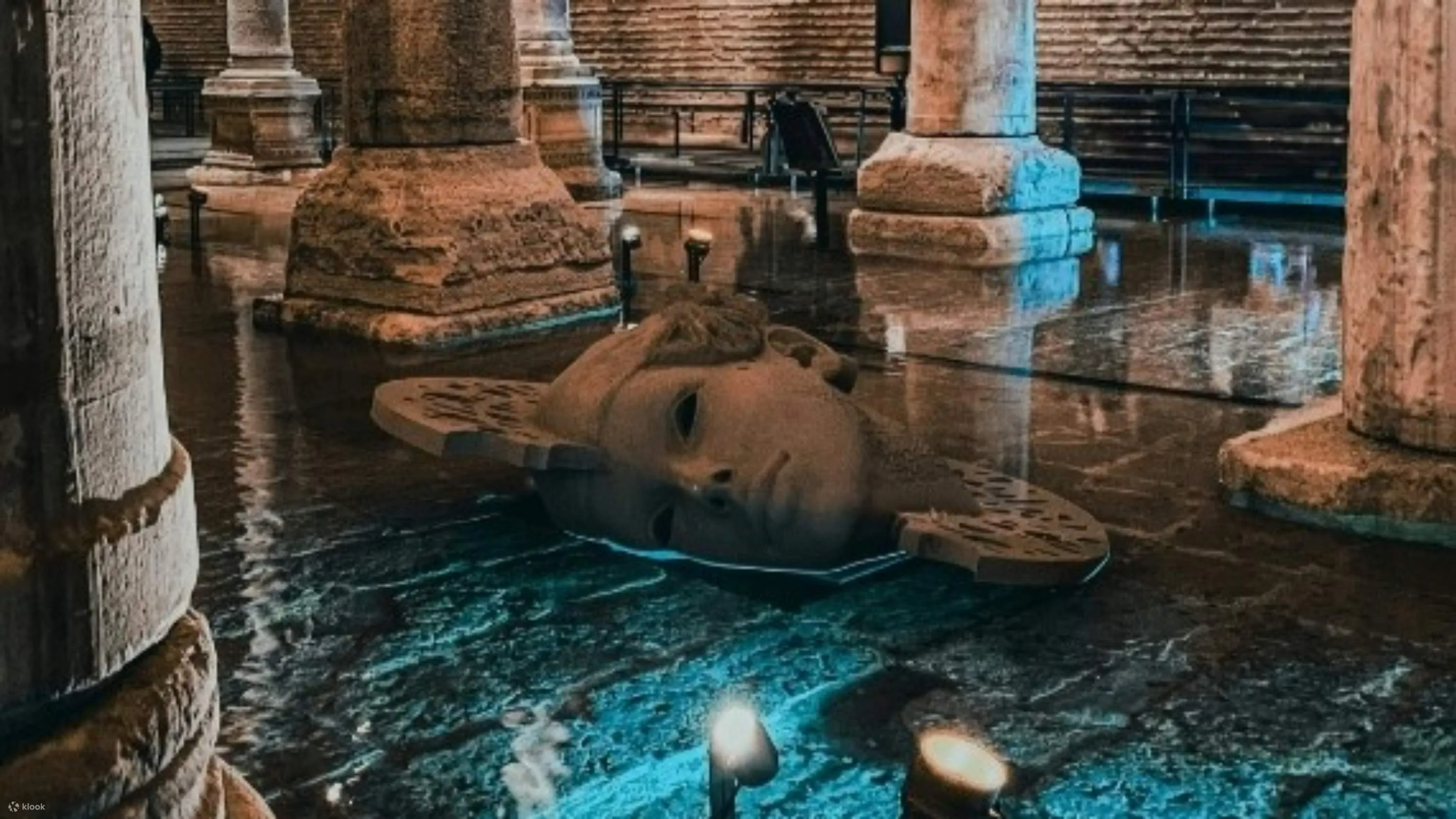 Statue face reflected in water