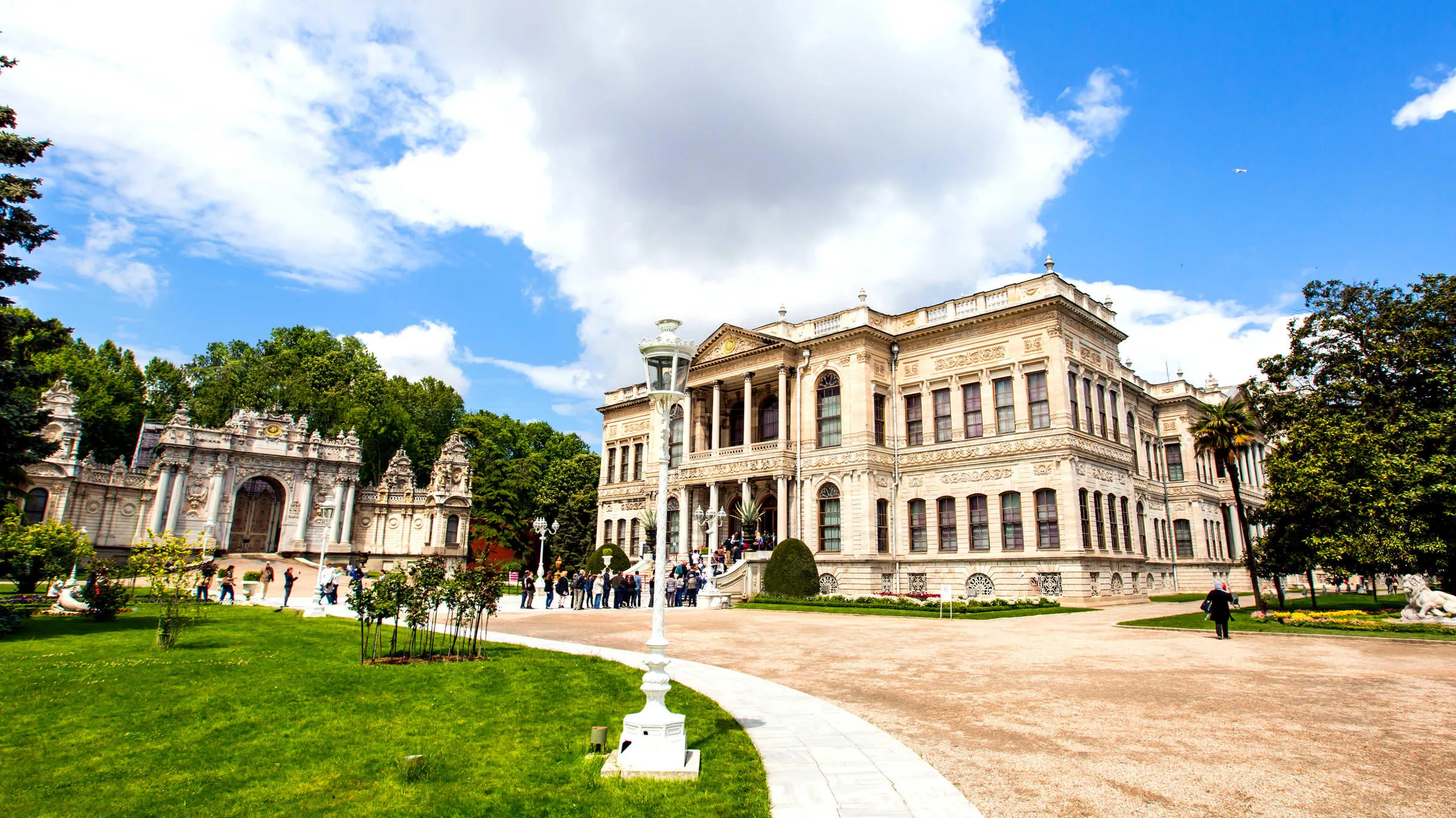 Main entrance approach to Dolmabahce Palace with visitors walking in