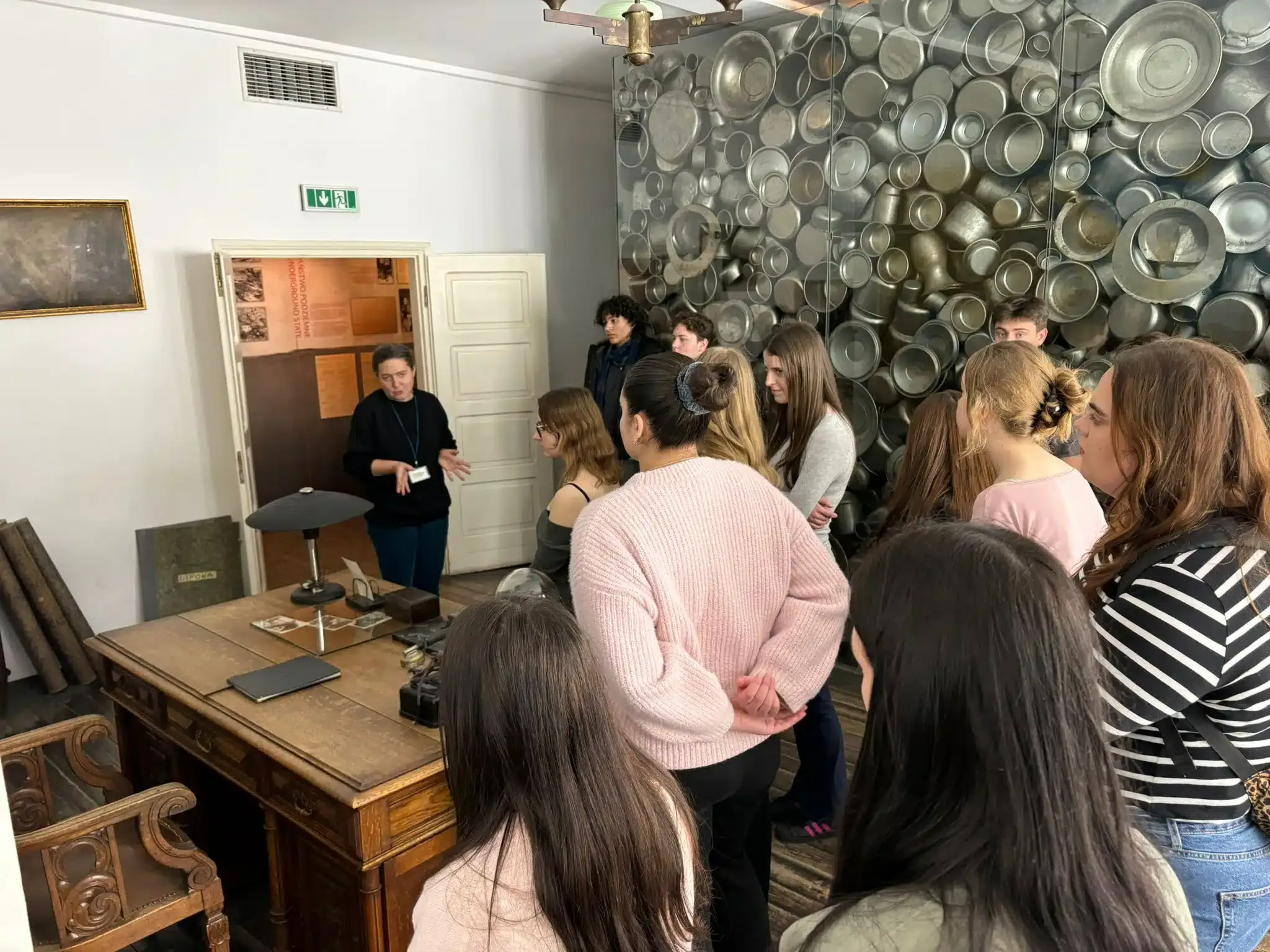 Group listening to a guide inside Schindler Factory Museum