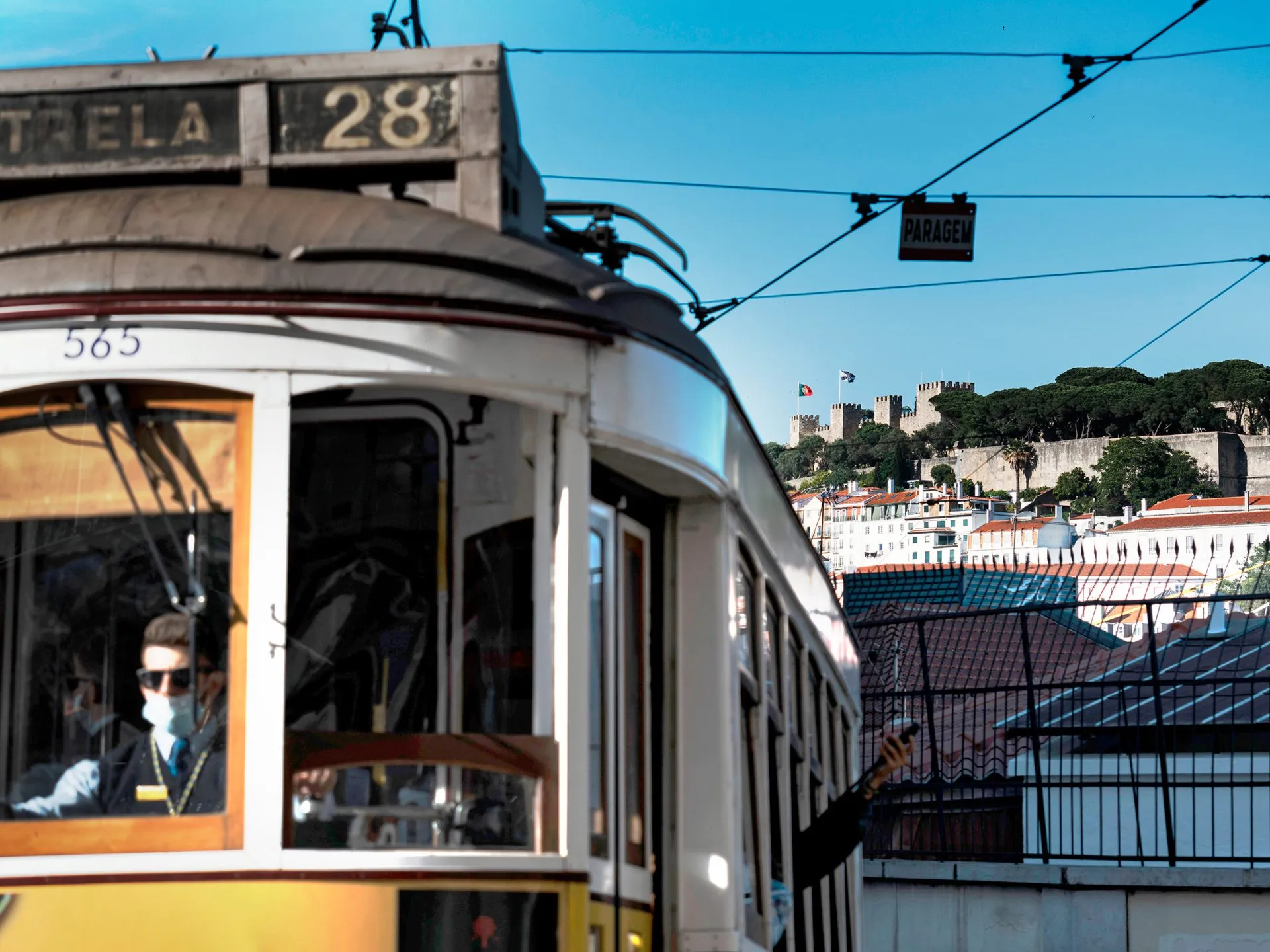 Historic tram passing near São Jorge Castle