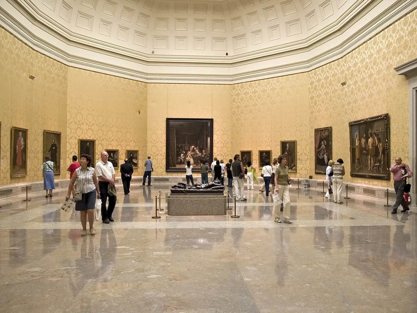 Main hall inside the Prado Museum with classical architecture and paintings