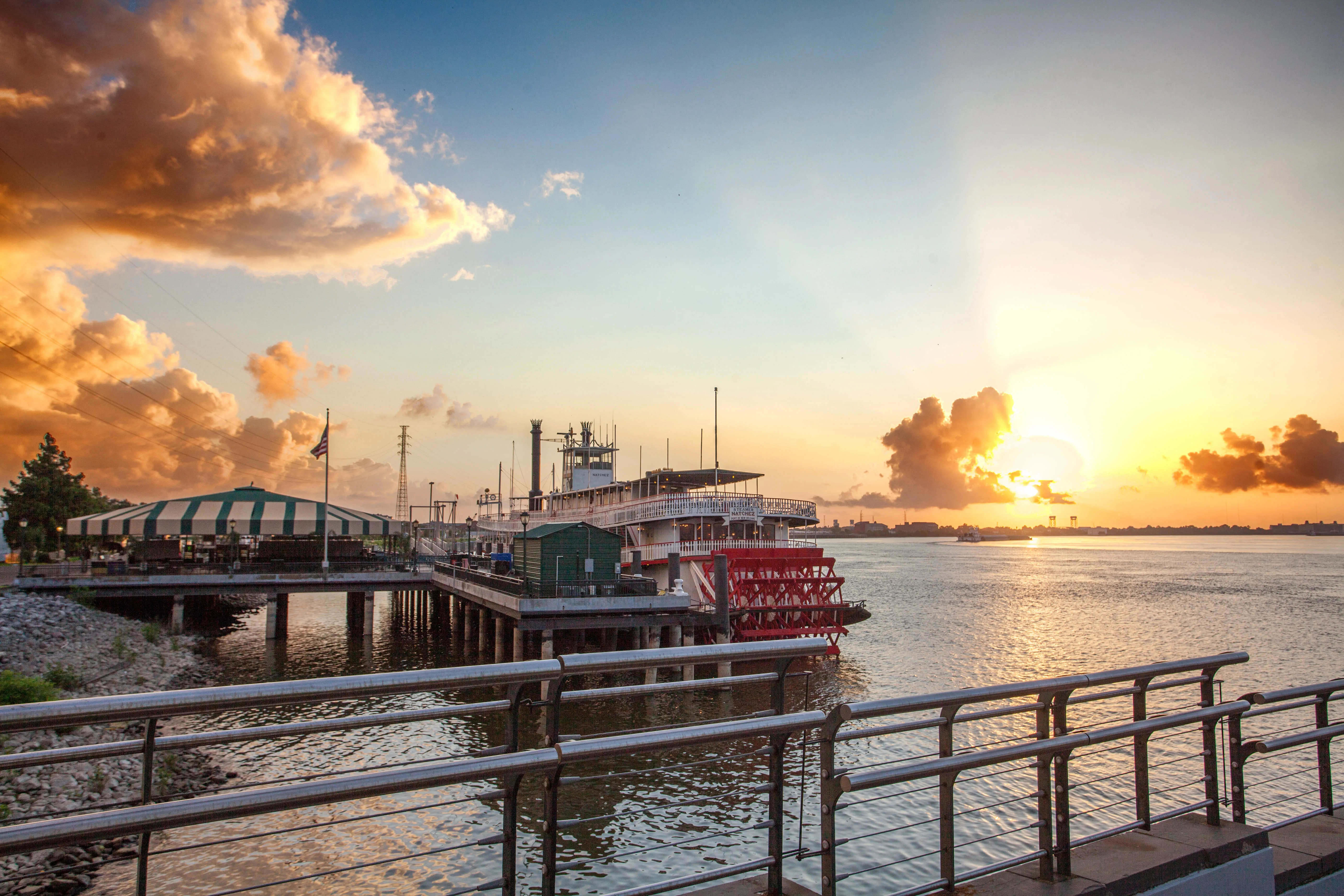 Paddlewheel steamboat docked at sunset on the Mississippi