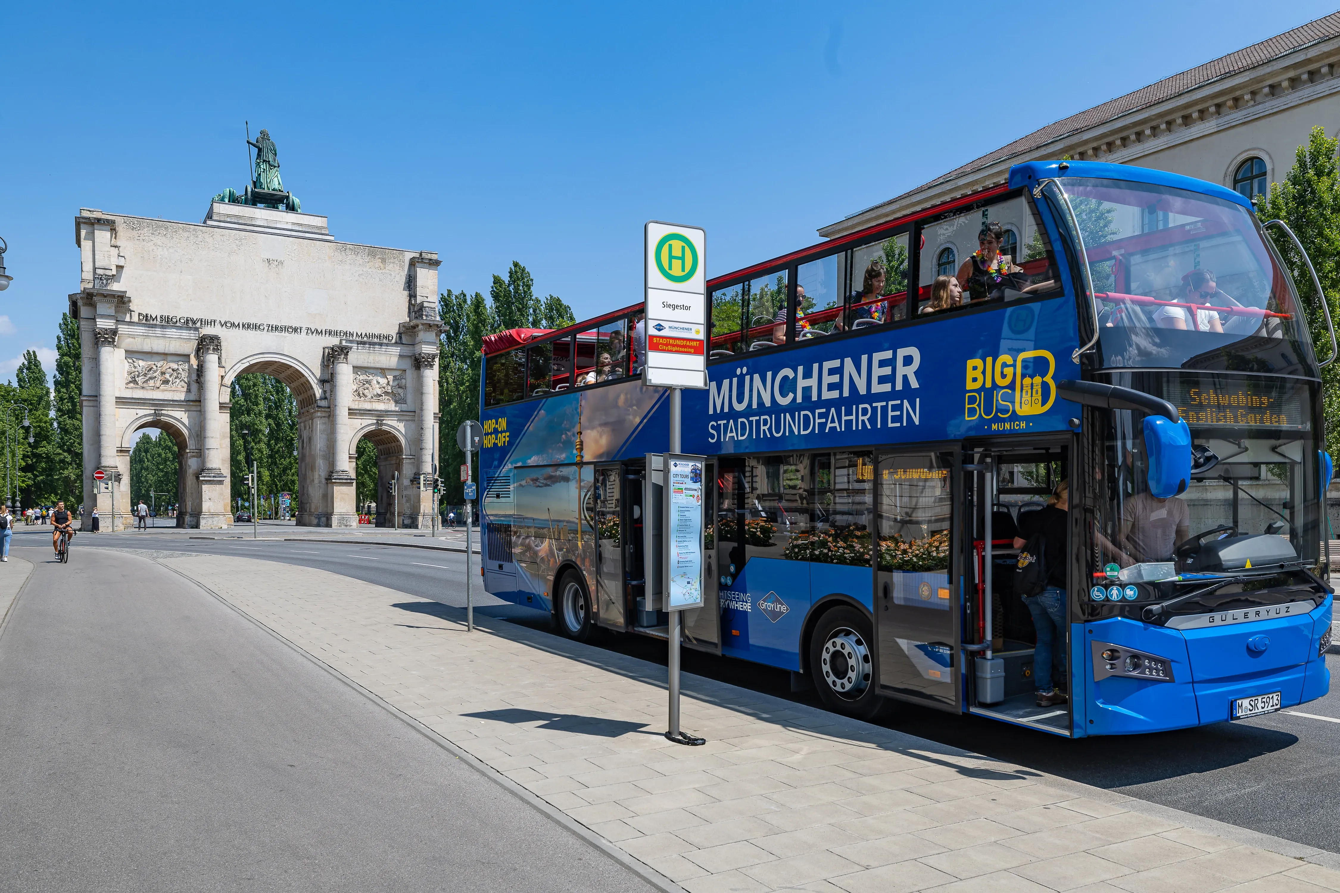 Sightseeing bus driving past the grand Nymphenburg Palace grounds