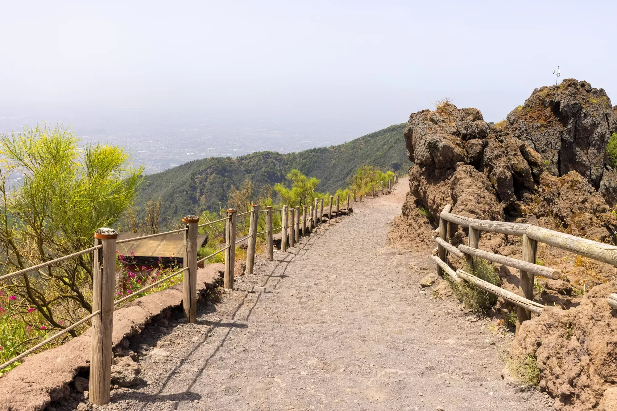 Families walking a gravel trail toward the Vesuvius crater