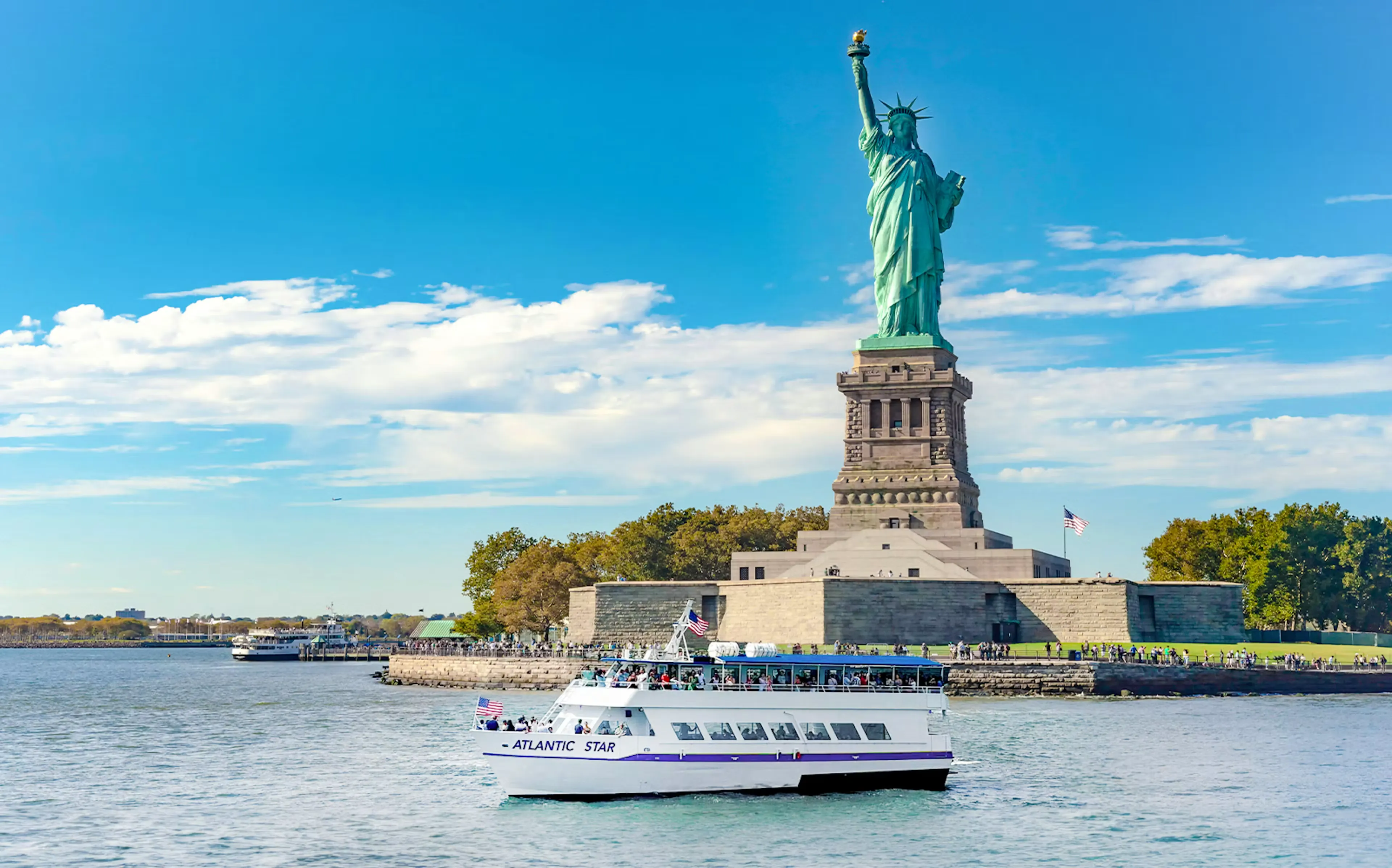 Cruise boat passing near the Statue of Liberty