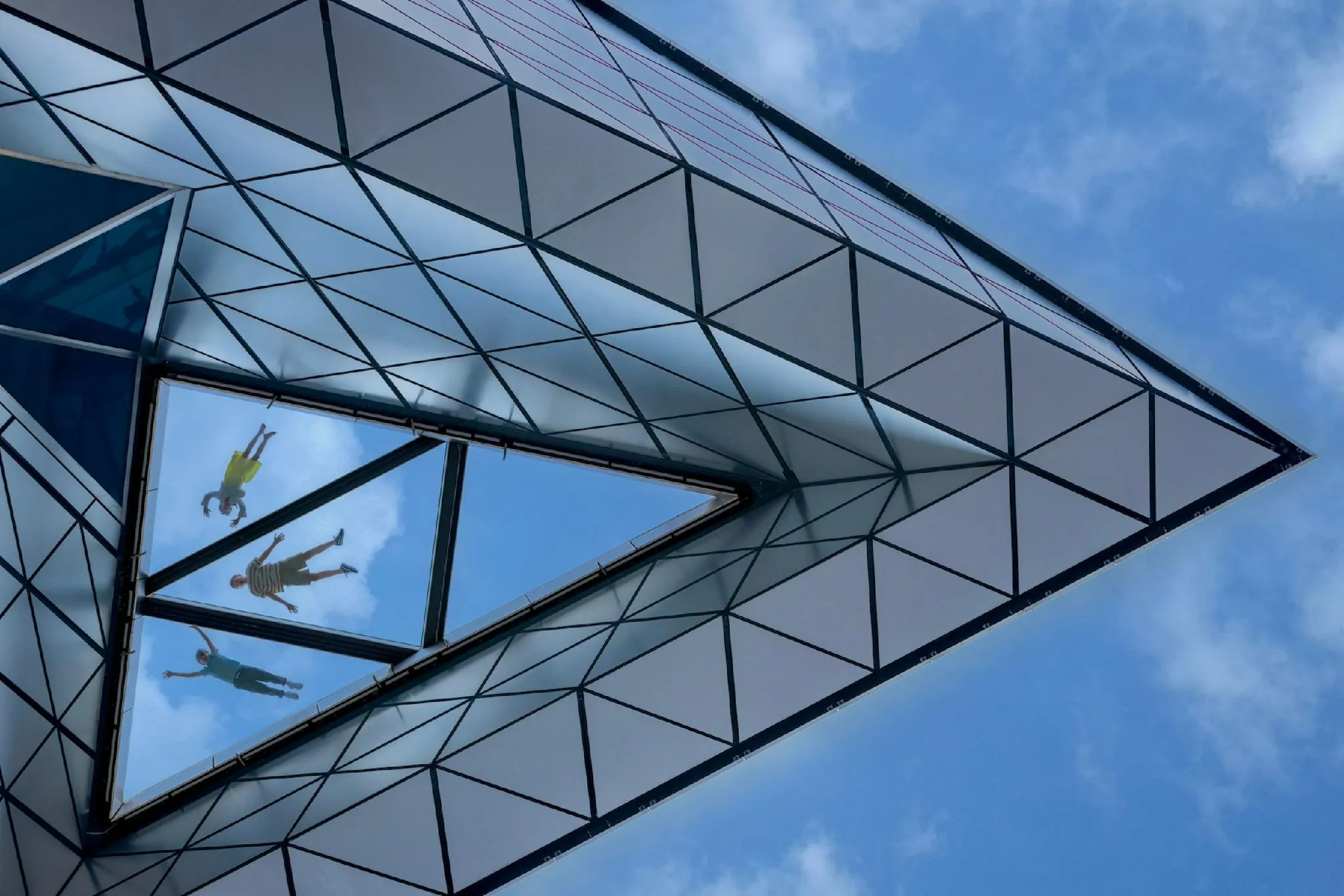 Visitors enjoying the glass floor at Edge