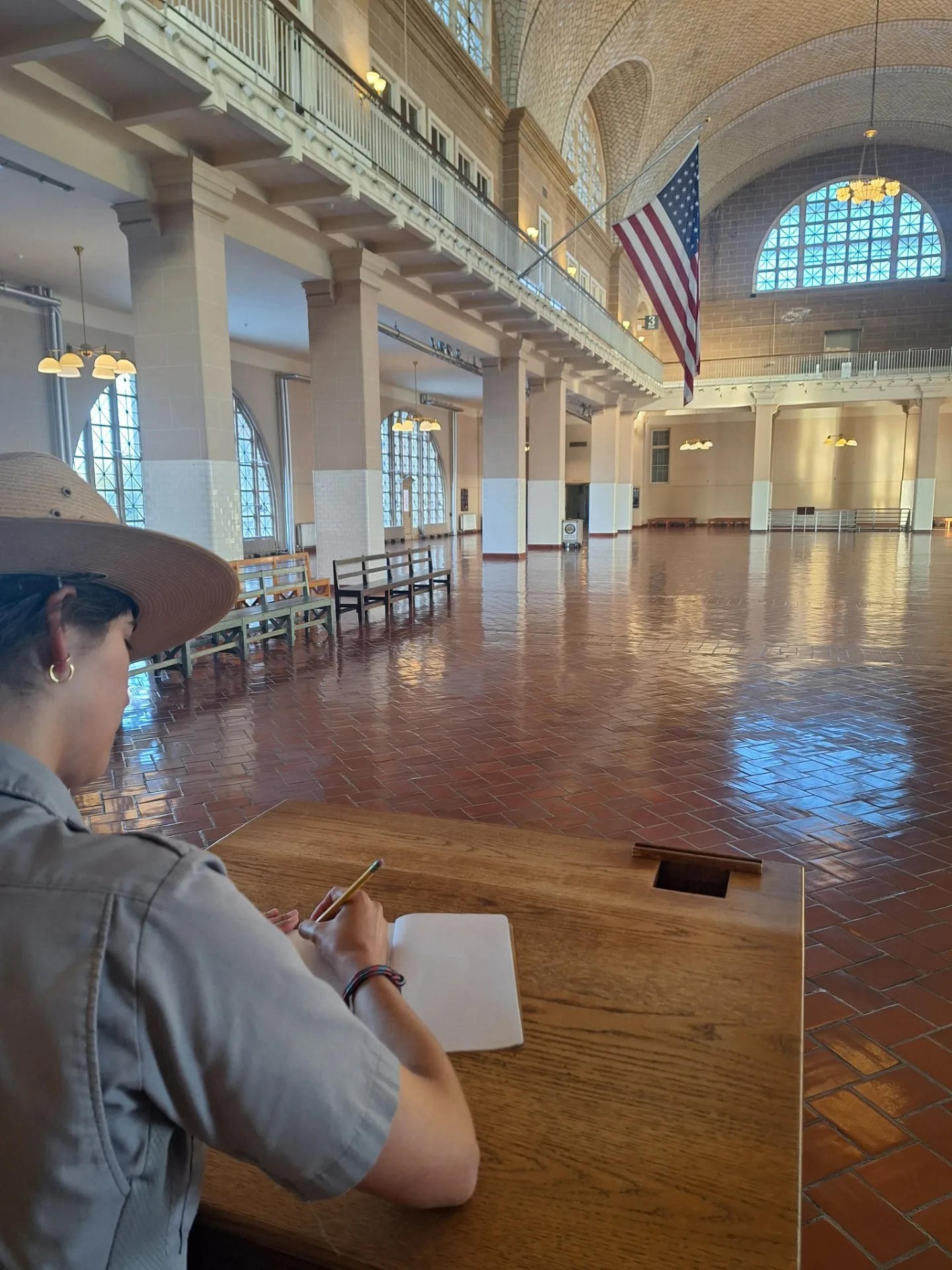 Park ranger writing in the Great Hall at Ellis Island