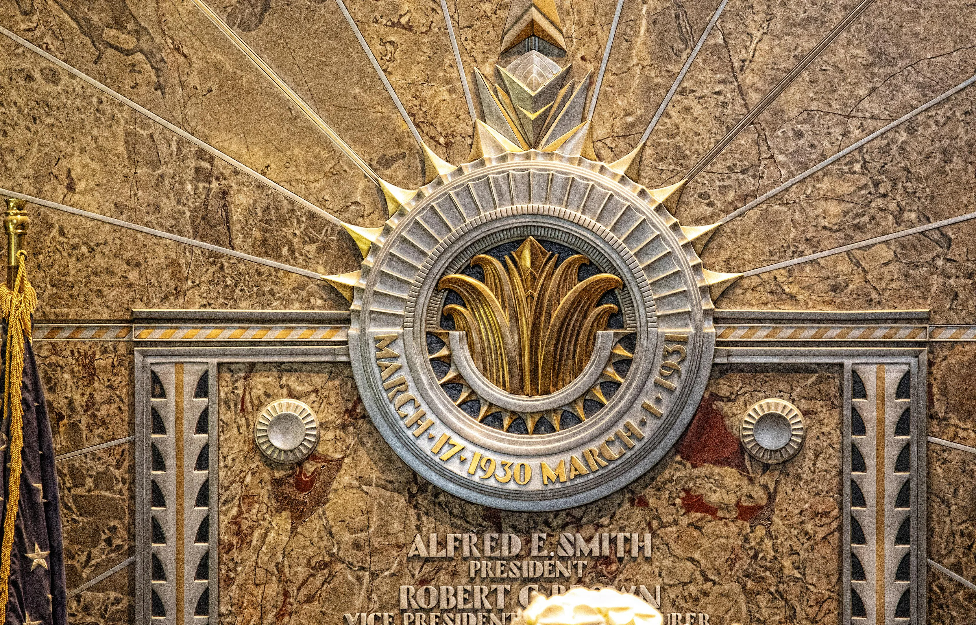Bronze plaque and geometric details inside ESB’s lobby