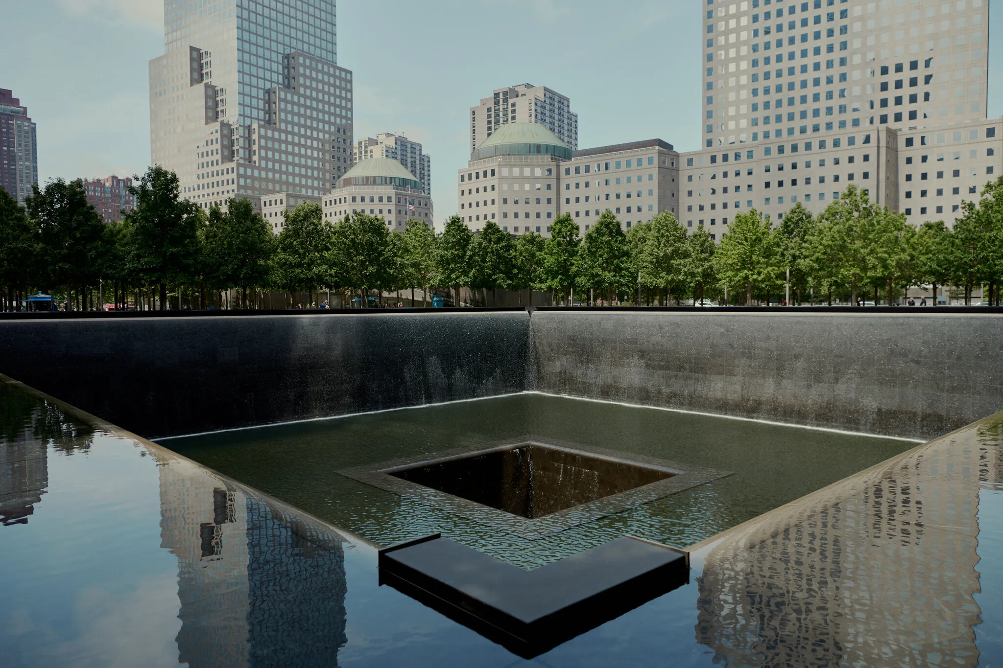 Waterfall edge of a memorial pool with bronze names