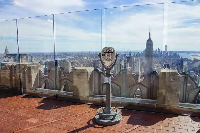 Visitors at Top of the Rock with Manhattan skyline around them