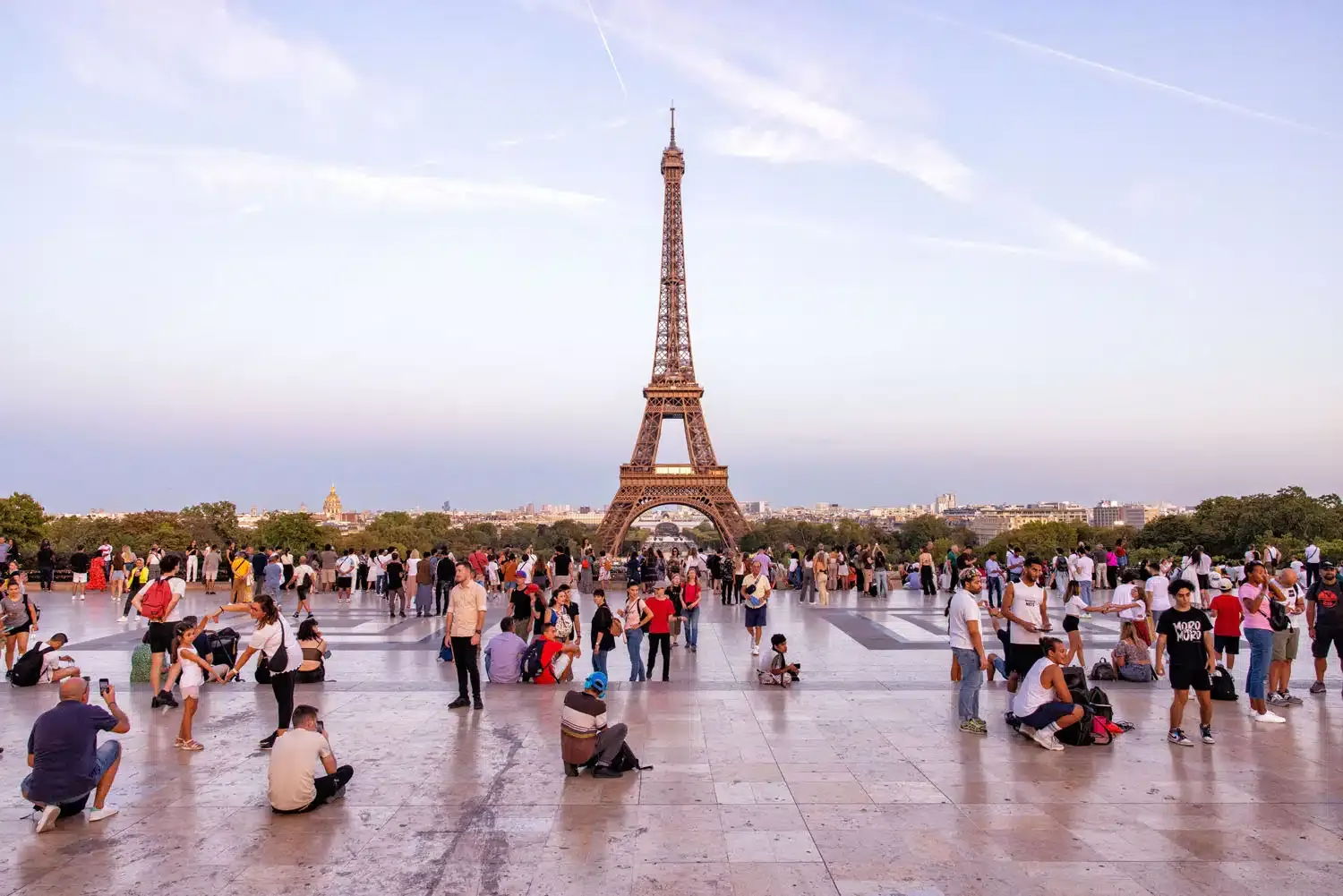 Nighttime Eiffel Tower illuminated, with reflections on the Seine