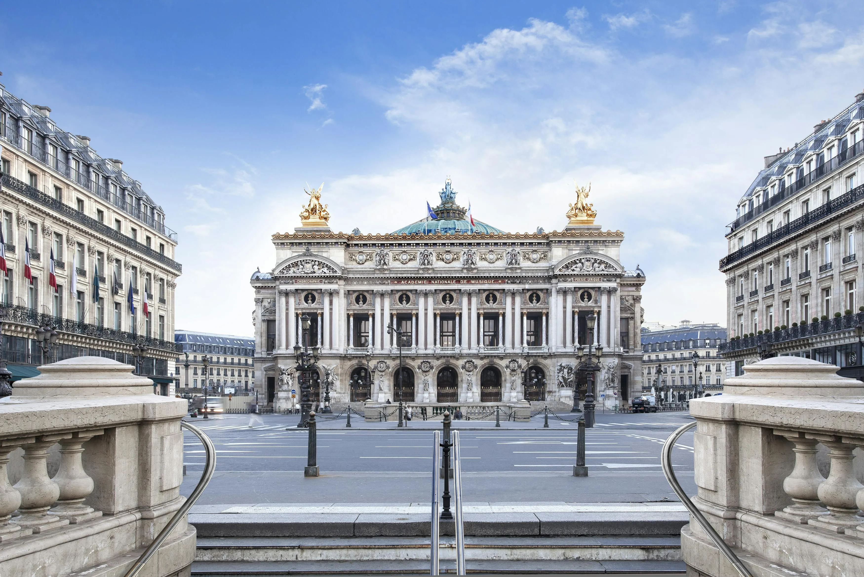 Wide urban view toward the Palais Garnier along the boulevard