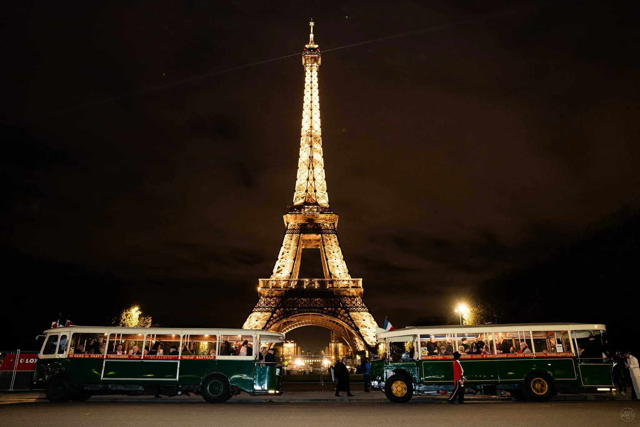 Historic bus parade near Eiffel Tower