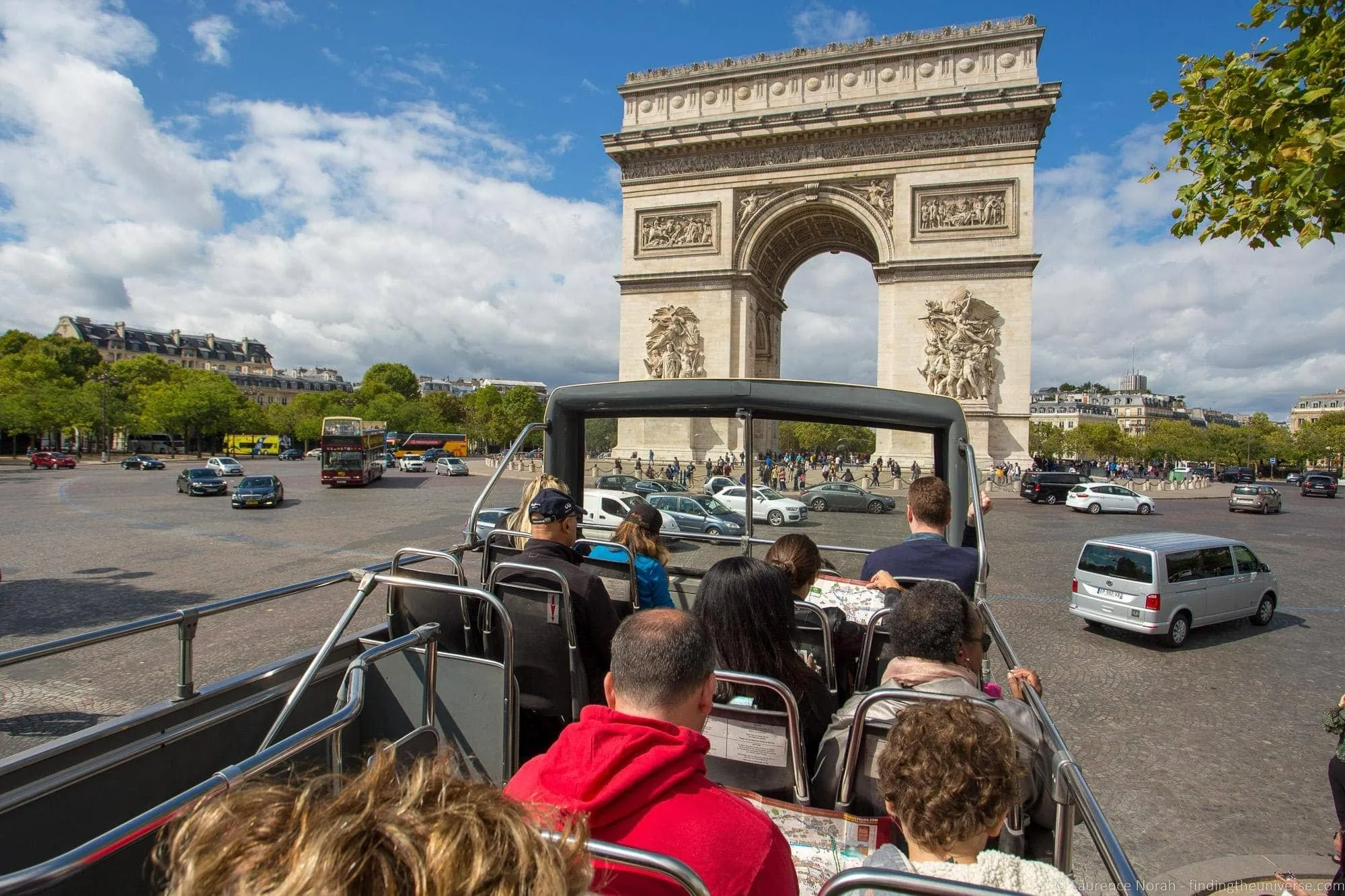 Passengers viewing Arc de Triomphe from bus roof