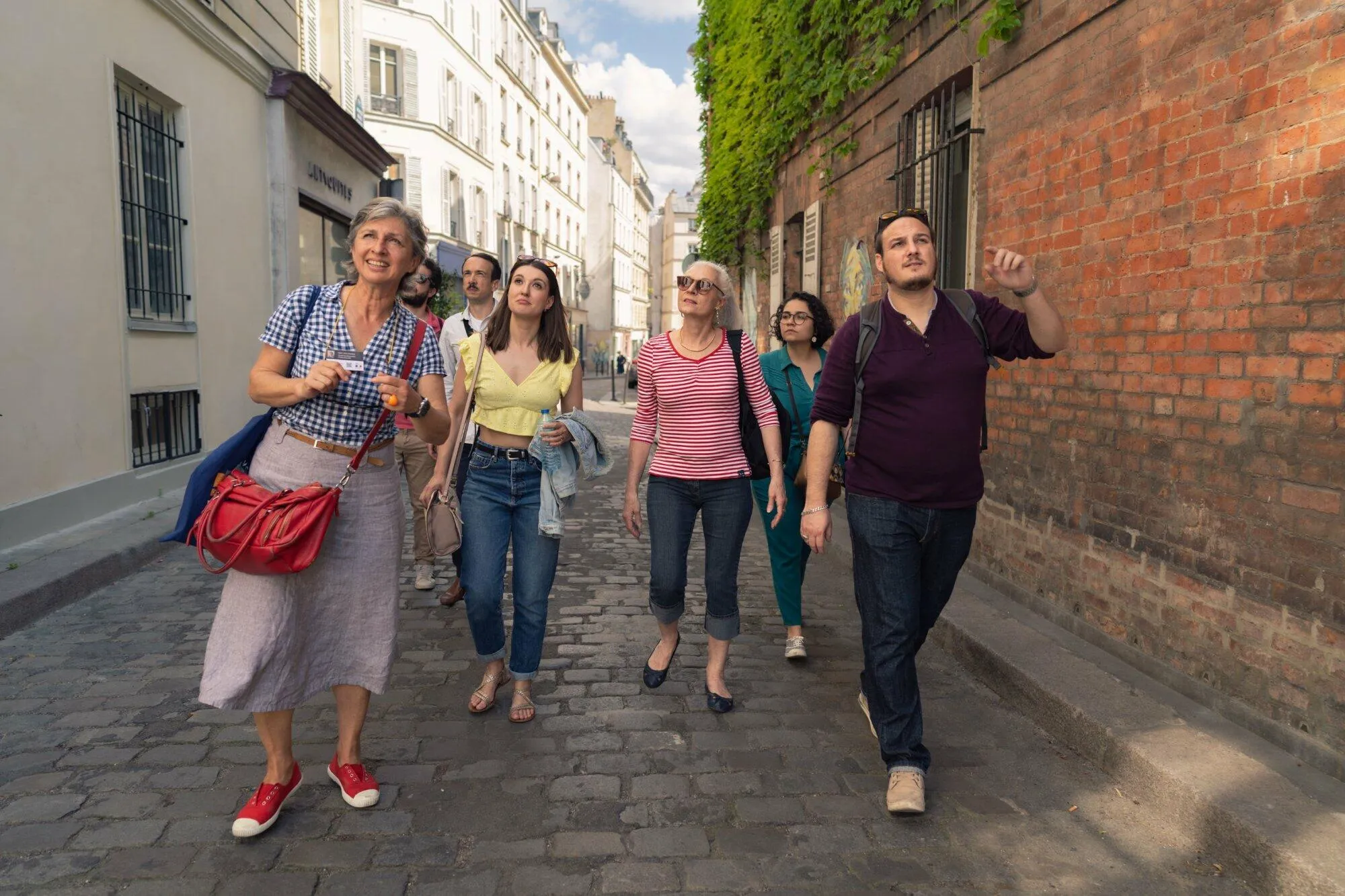 A guide leading a small group through Montmartre streets