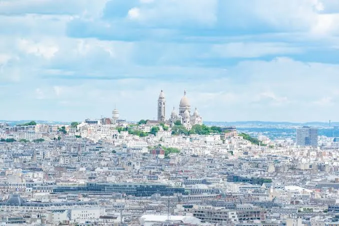 Wide view over Montmartre with rooftops and the hill stretching across Paris