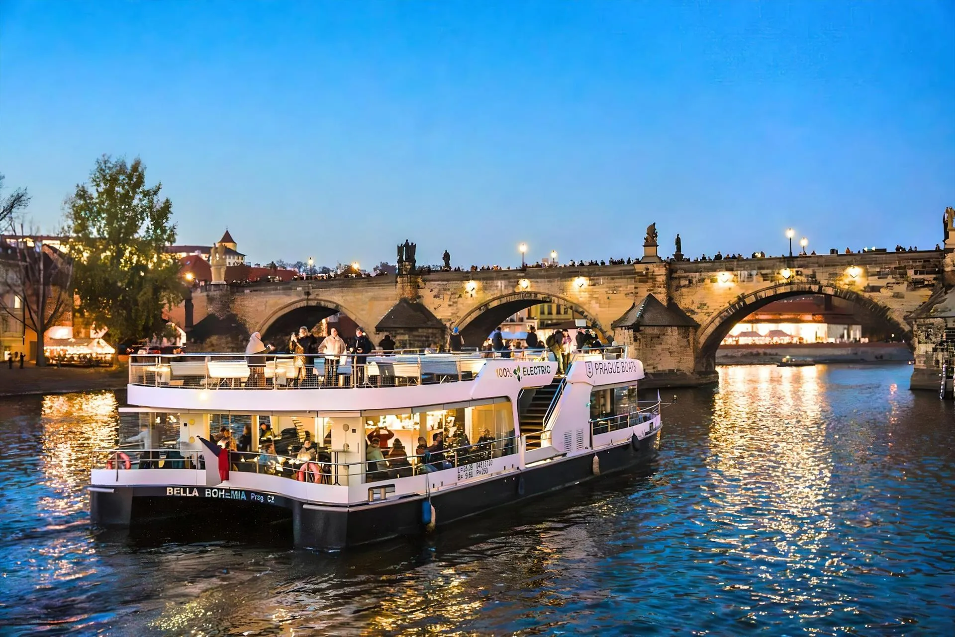 Modern eco-boat cruising on the Vltava river at night