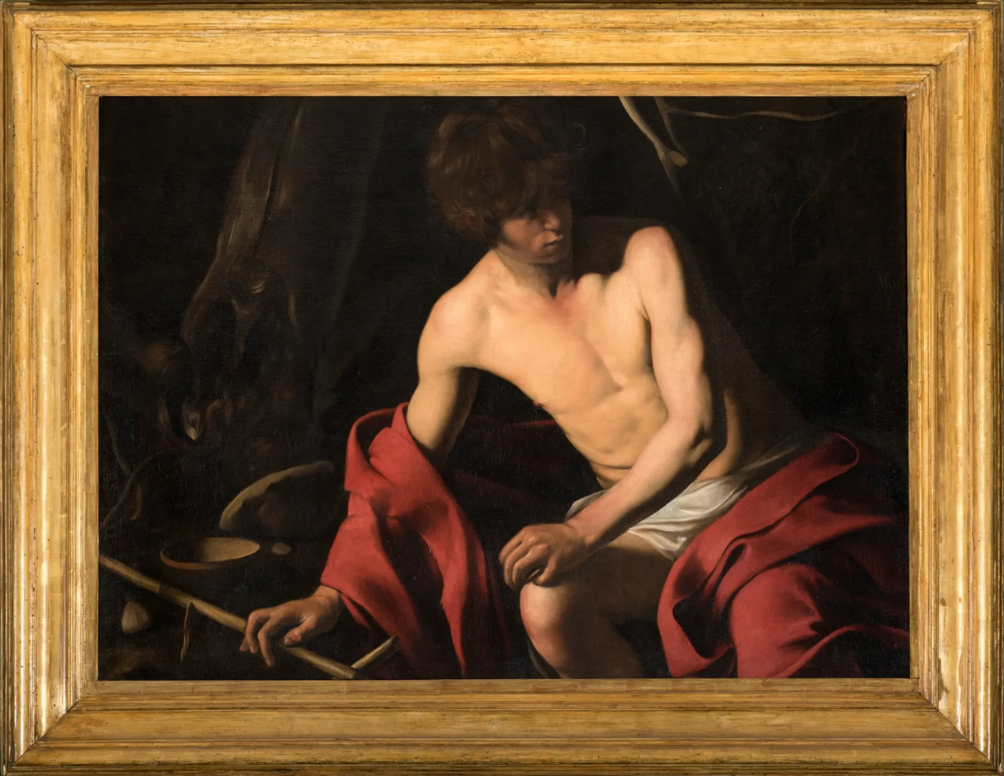 Caravaggio painting of Saint John the Baptist displayed in gallery room