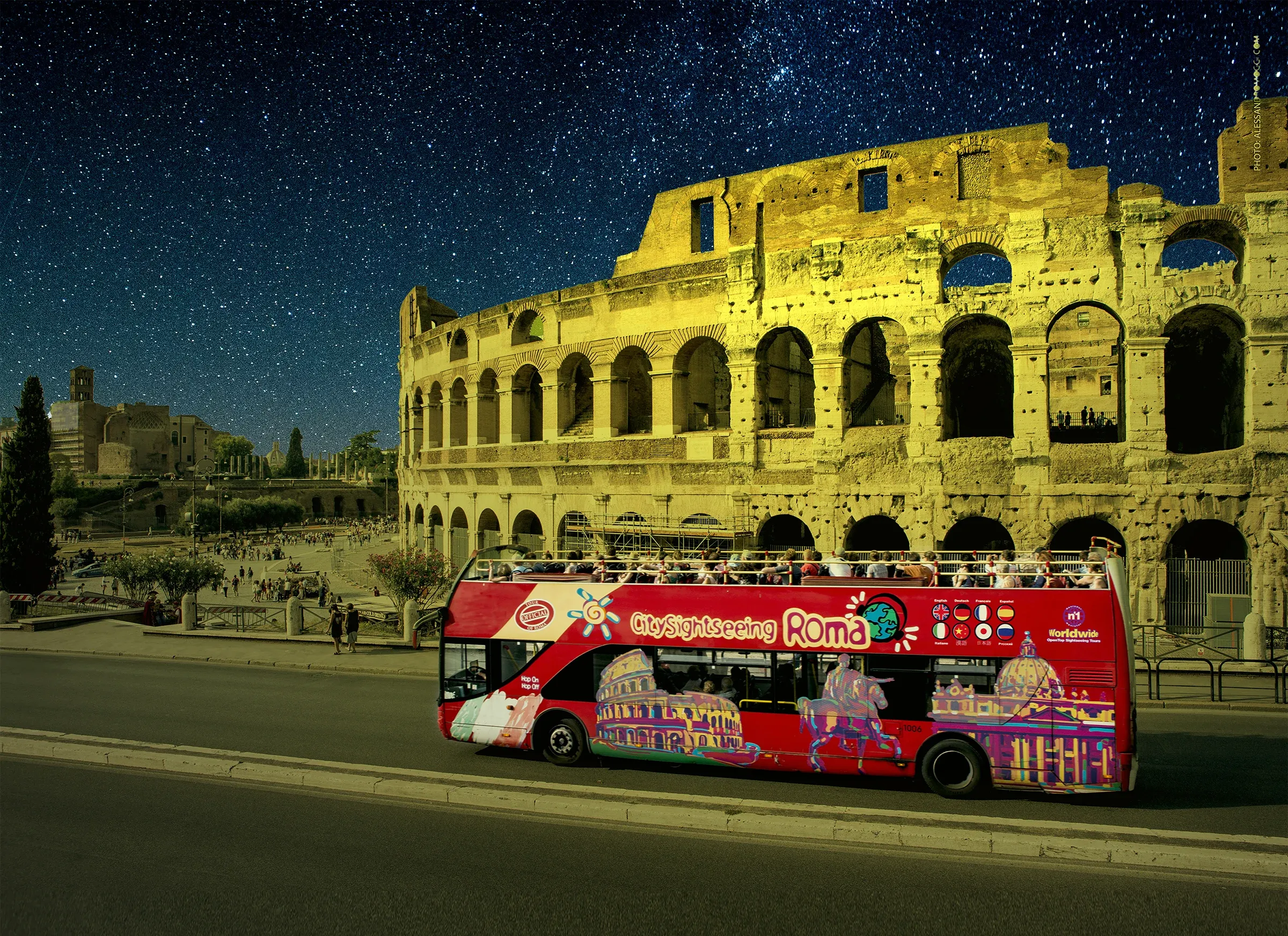 The Colosseum glowing at night under a starry sky