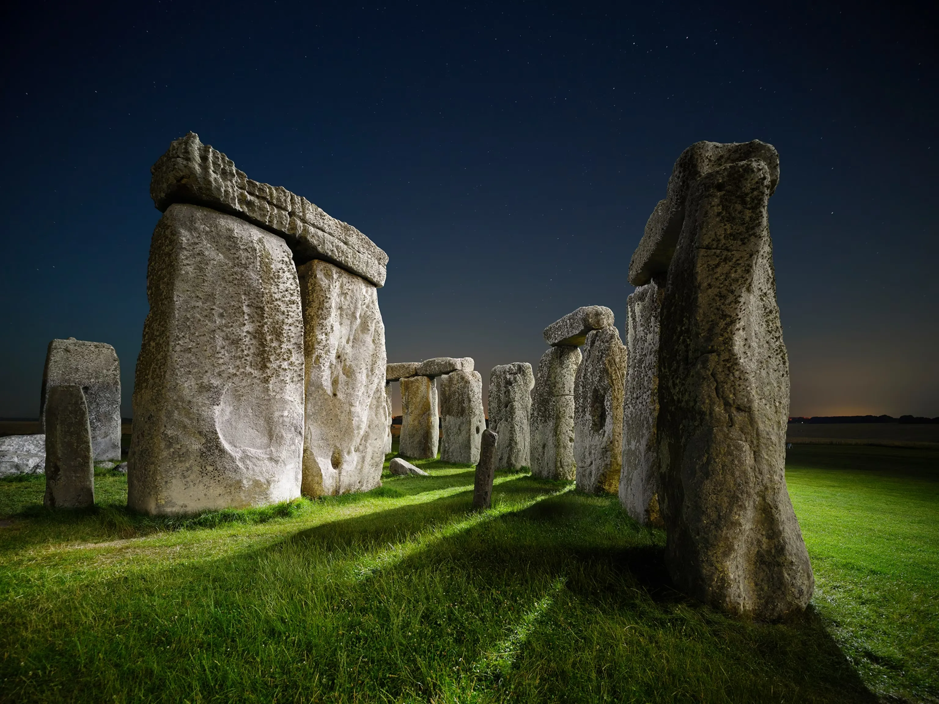 Stonehenge at night under a dark sky
